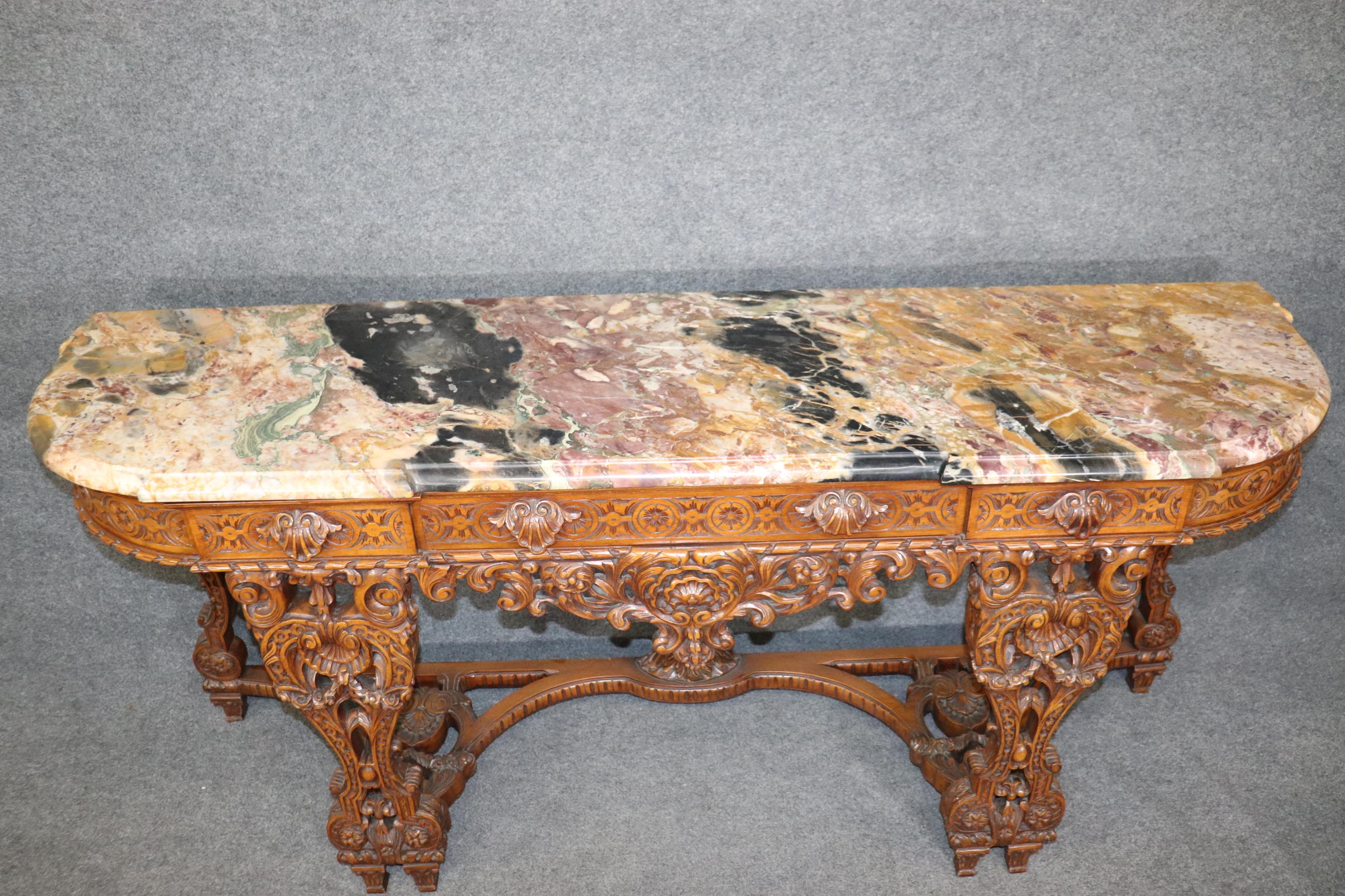 This is a spectacular, and I can't possibly overstate, perhaps one of the most dazzling marble top console tables or sideboard of grand scale online today. The marble is Breccia Vandome, a highy prized harlequin of colors resulting from natural