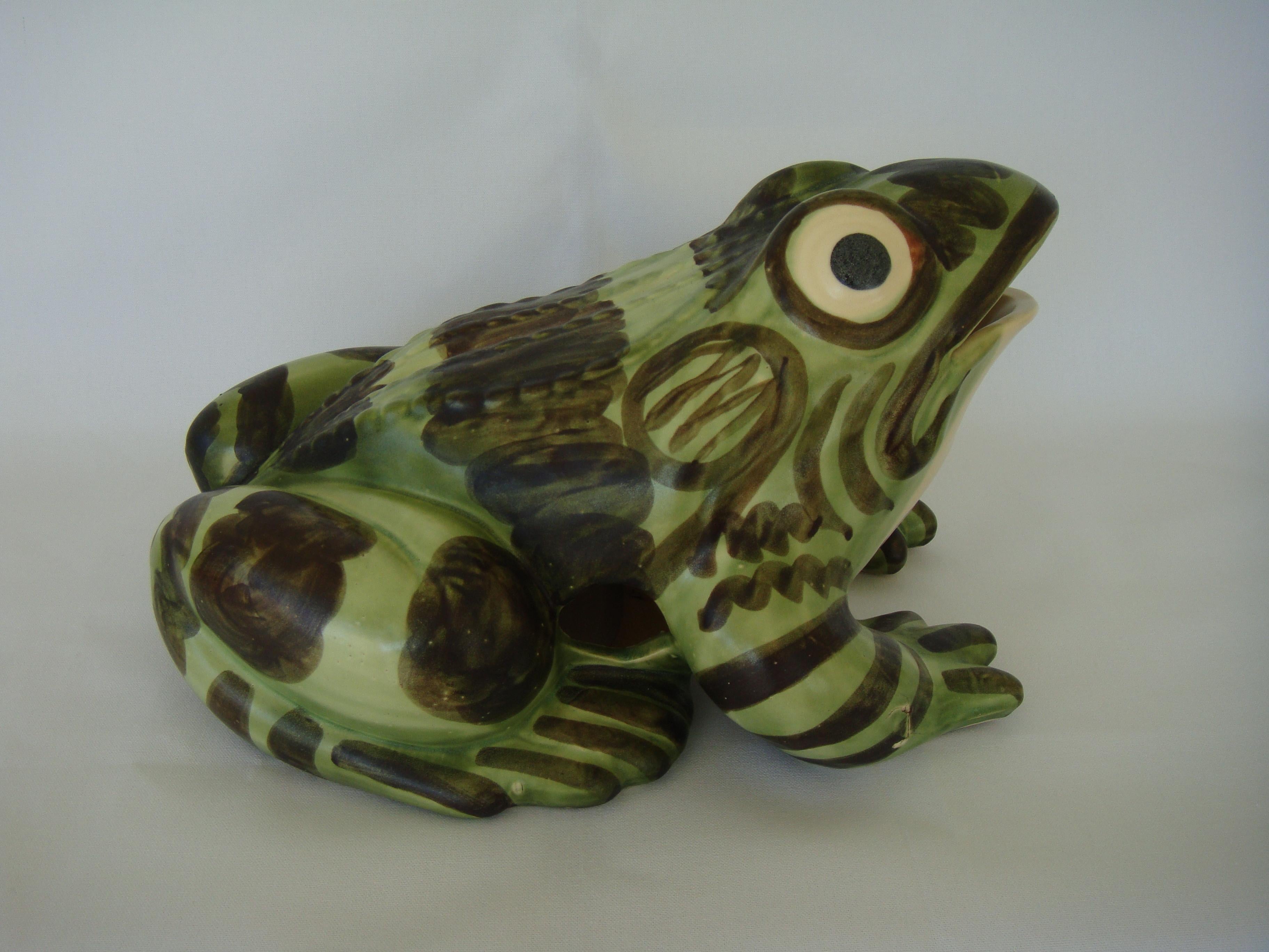 A scarce massive sculpture of a whimsical smiling frog, the largest made by Brush Mccoy. Every piece was individually hand-painted, giving each frog its own unique personality. Check out the bug eyes and sly grin. As you can see, the execution of