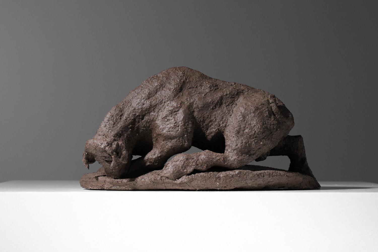 Scultura francese che rappresenta un toro realizzata interamente in argilla chamotte marrone.  Forma massiccia e grezza. Buone condizioni d'epoca, da notare il restauro della coda (vedi foto). Firma sulla ceramica: AFS.