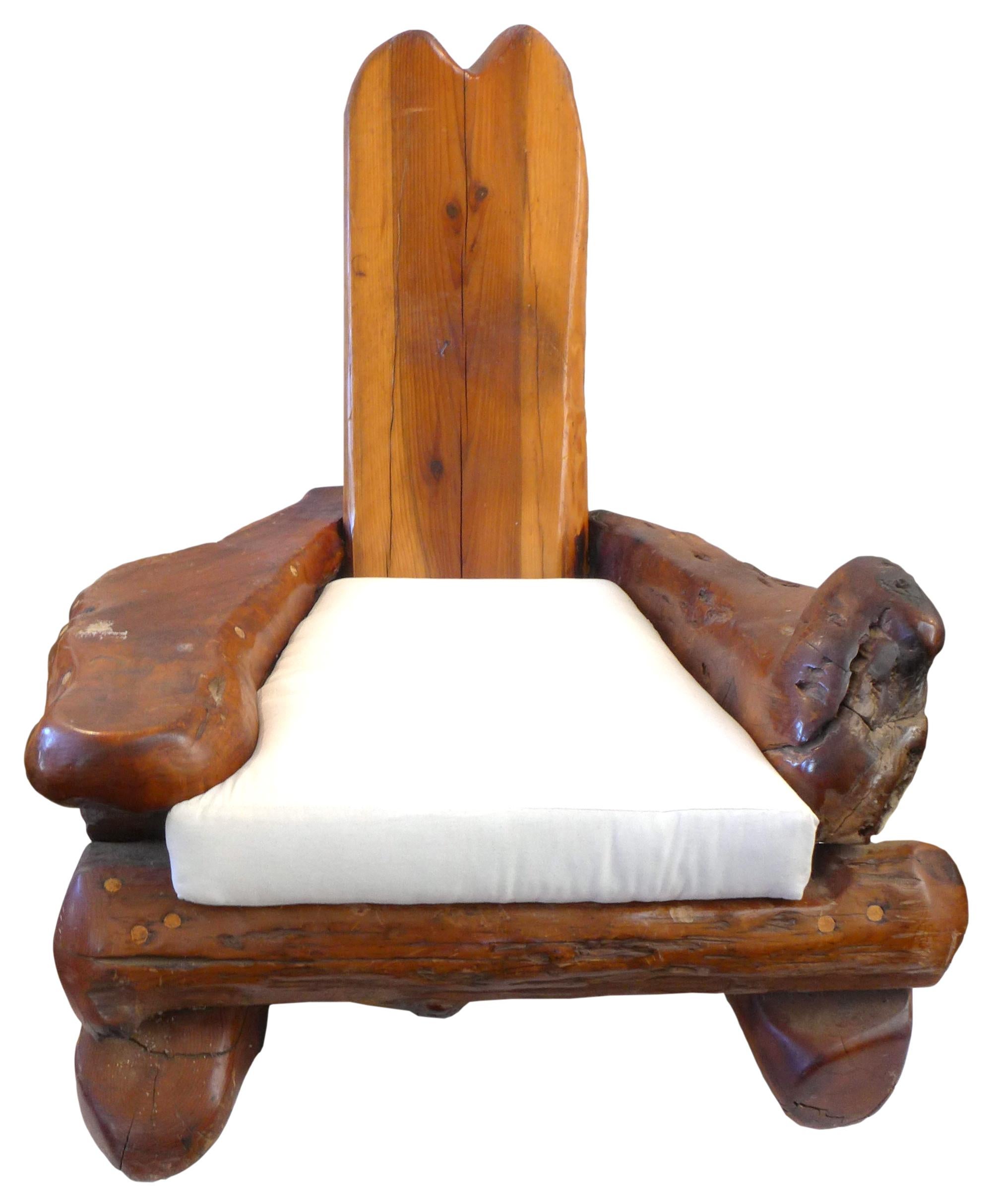 A fantastic, massive California craft redwood lounge chair.  An outstanding element of monumental proportions; a frame constructed of chunky redwood log fragments with a generously sloping back.  Impressive oversized proportions, big in every way,