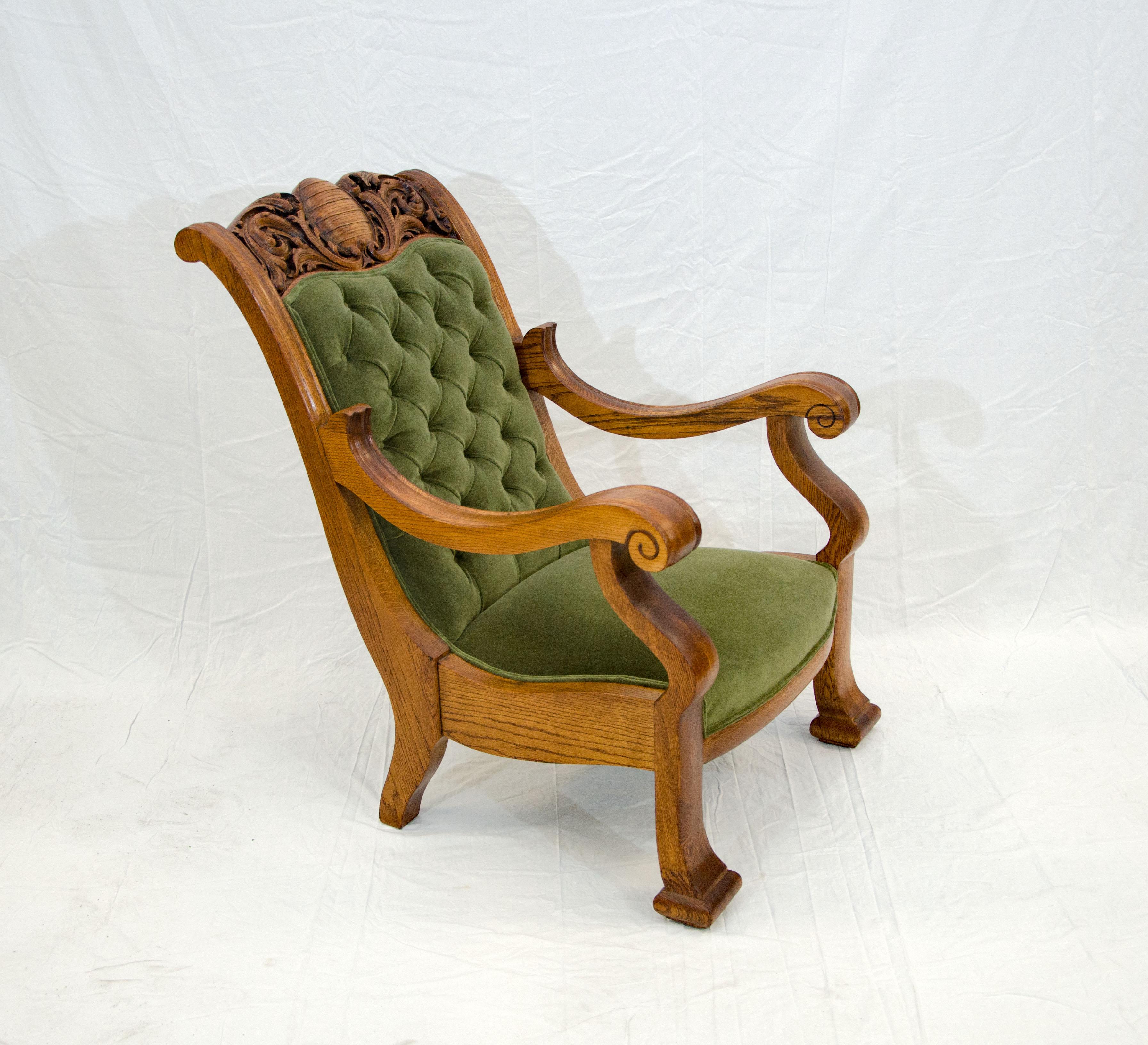 A gorgeous massive carved oak armchair that would really make a statement in your living room, library, or office space. The new upholstery process included retying the springs, the back was button tufted as was originally designed, and the entire
