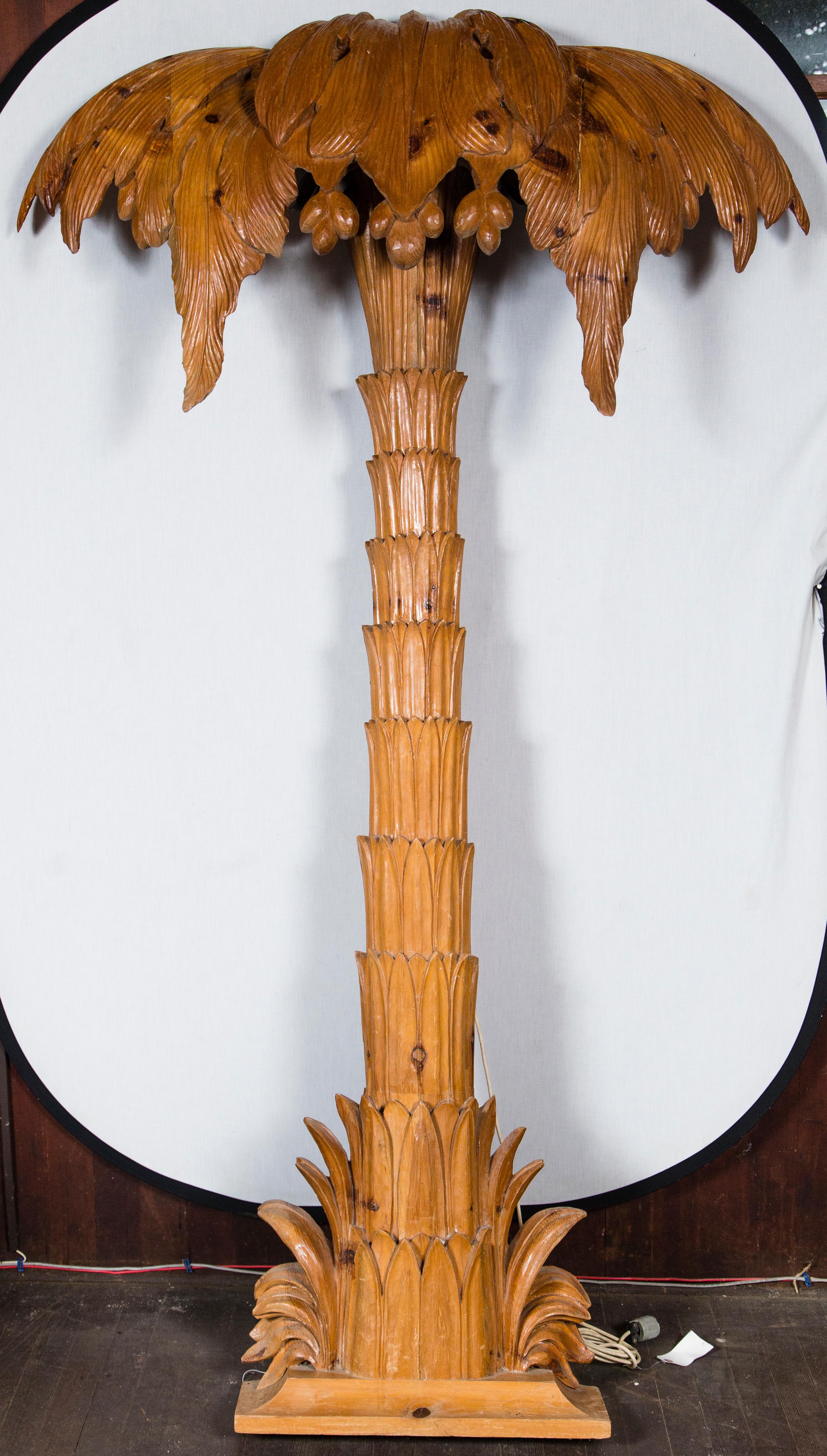 A grand carved pilaster style wood palm tree with tiny lights.
  