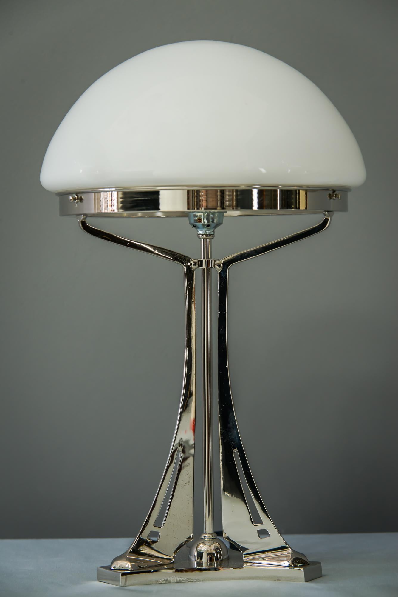 Massive cast table lamp in the style of jugendstil (nickel-plated)
This is a reproduction.
We have also the same in brass
Opal glass.
Depending on the order quantity it can take up to 2 weeks to finish the lamps.