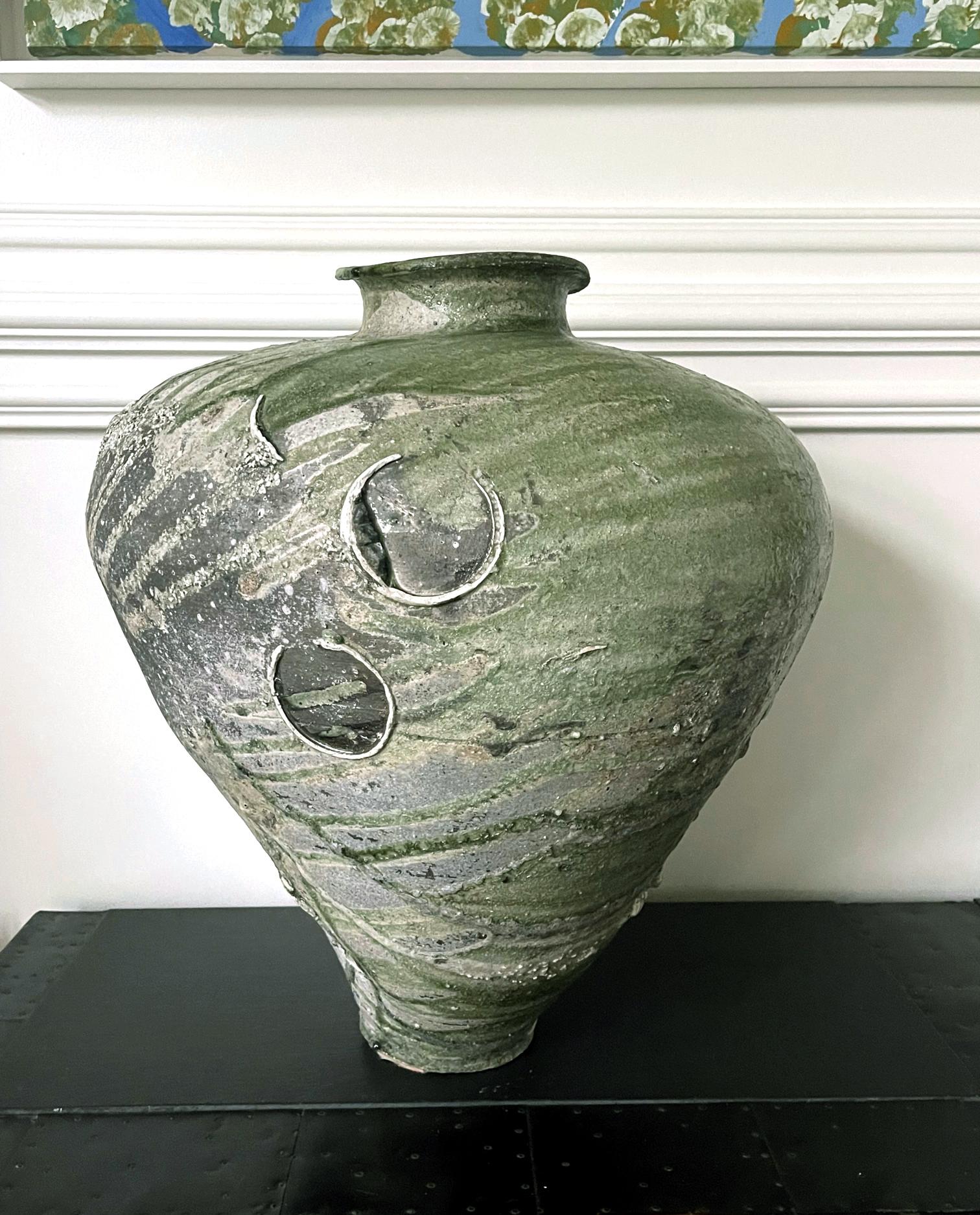 A massive and magnificent ceramic Tsubo jar by Japanese potter Tsujimura Yui (1975-). Inspired by the techniques and aesthetics of the early medieval Sue ware, the artist hand builds an impressive voluminous oviform, irregular by intention, from a