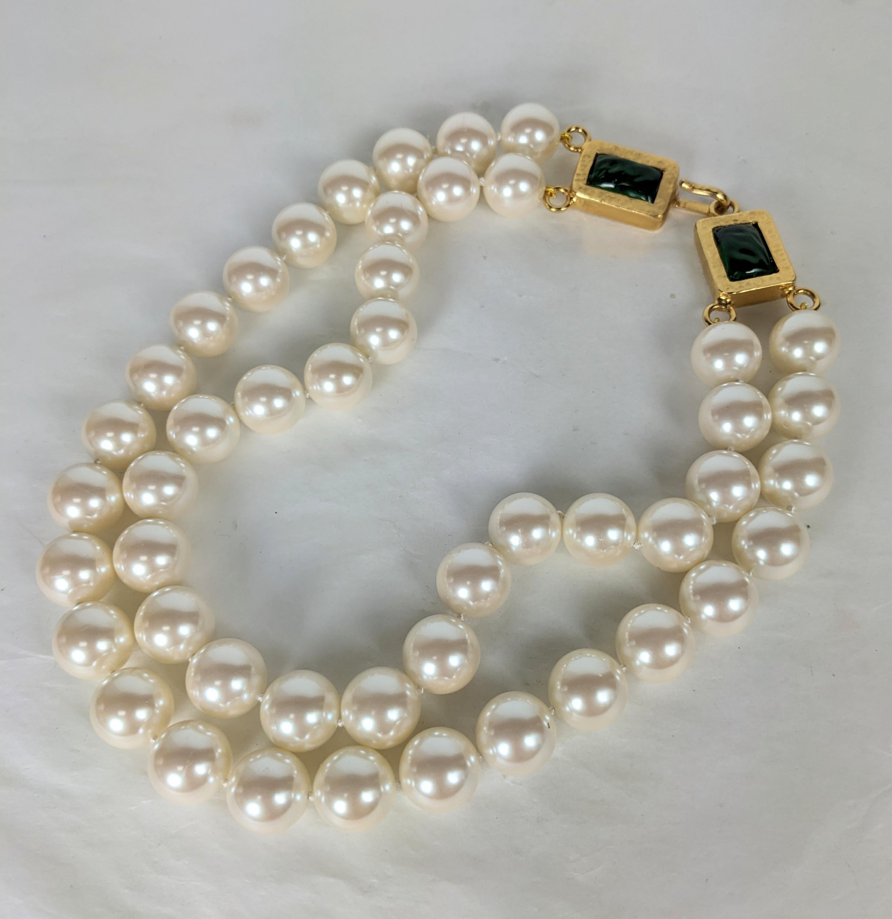 Timeless, massive Chanel double strand pearl  statement necklace. Of handmade, hand knotted Gripoix glass pearls, with large Byzantine clasp in hammered gilt bronze with emerald poured Gripoix glass. 1990's France. Excellent Condition. Signed on