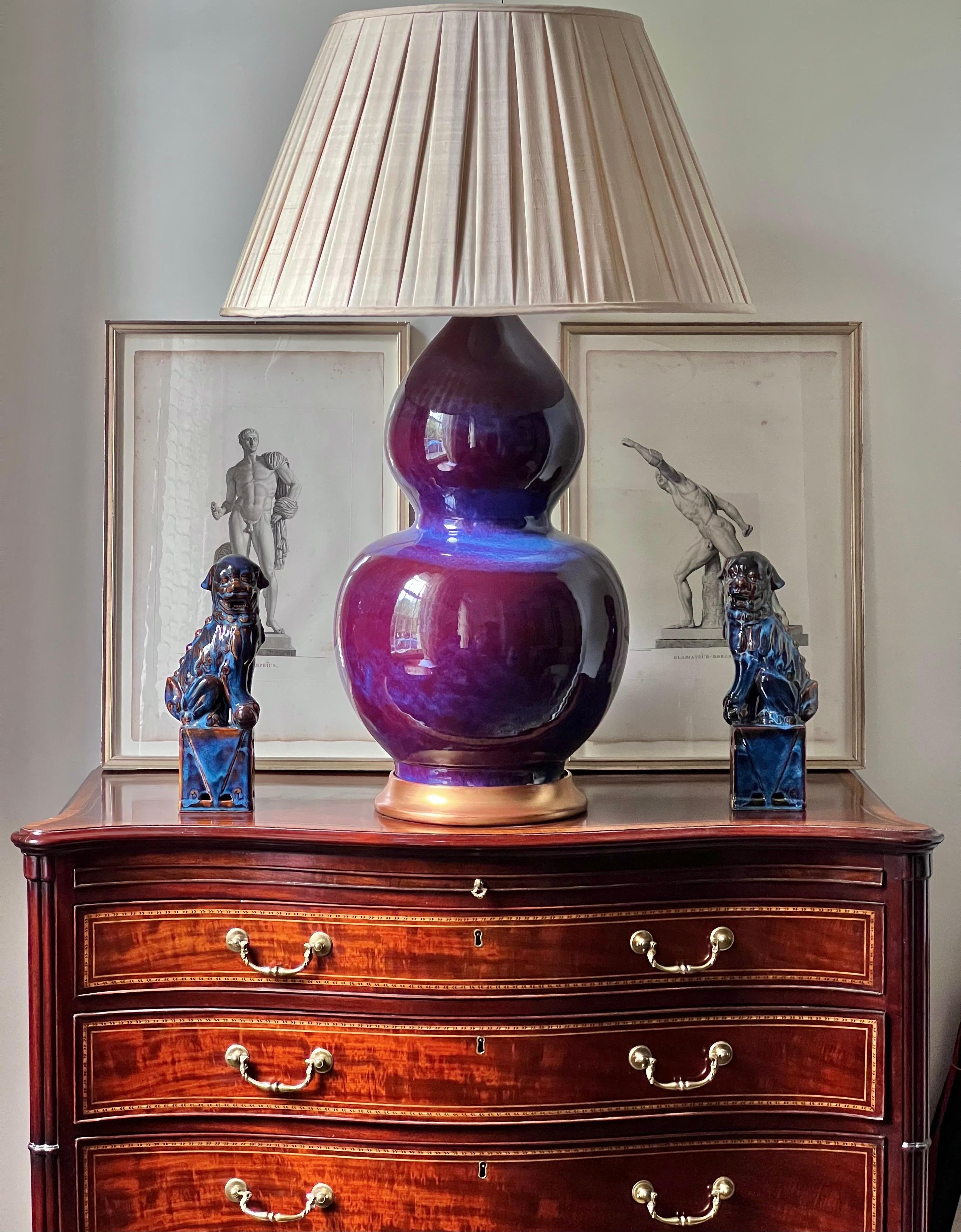 A wonderfully decorative 'double gourd' or huluping vase of massive proportions, beautifully glazed with purple and blue streaks, mounted as lamp.
China, 20th century

Why we like it
We love the opulence of colours and the intricate pattern of the