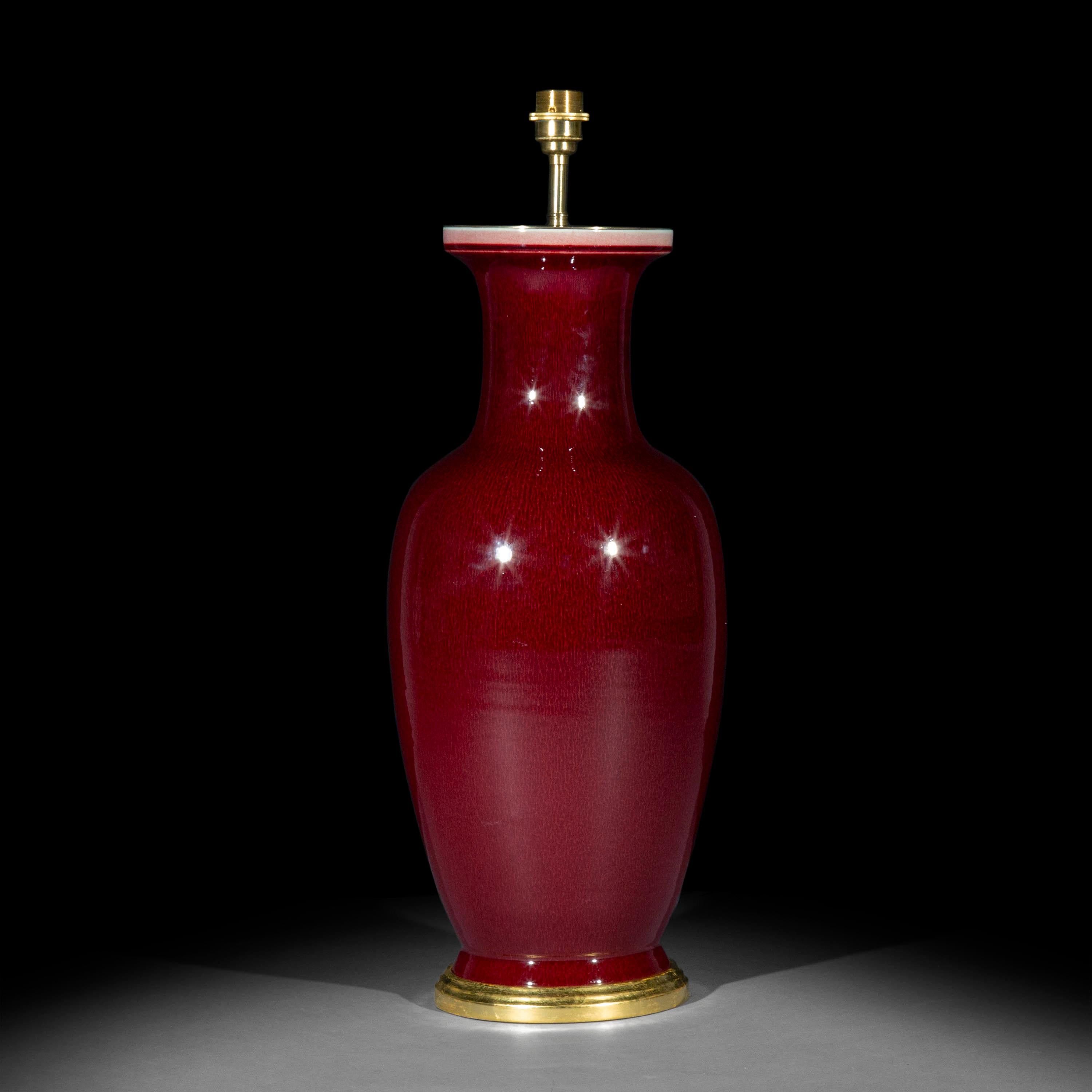 A stunning Chinese export Sang de Boeuf (Oxblood) glazed vase of superb quality, mounted as table lamp on a handmade water-gilded base.
20th century.

Why we like it
We love its impeccable shape and the massive scale of this vase which make it a