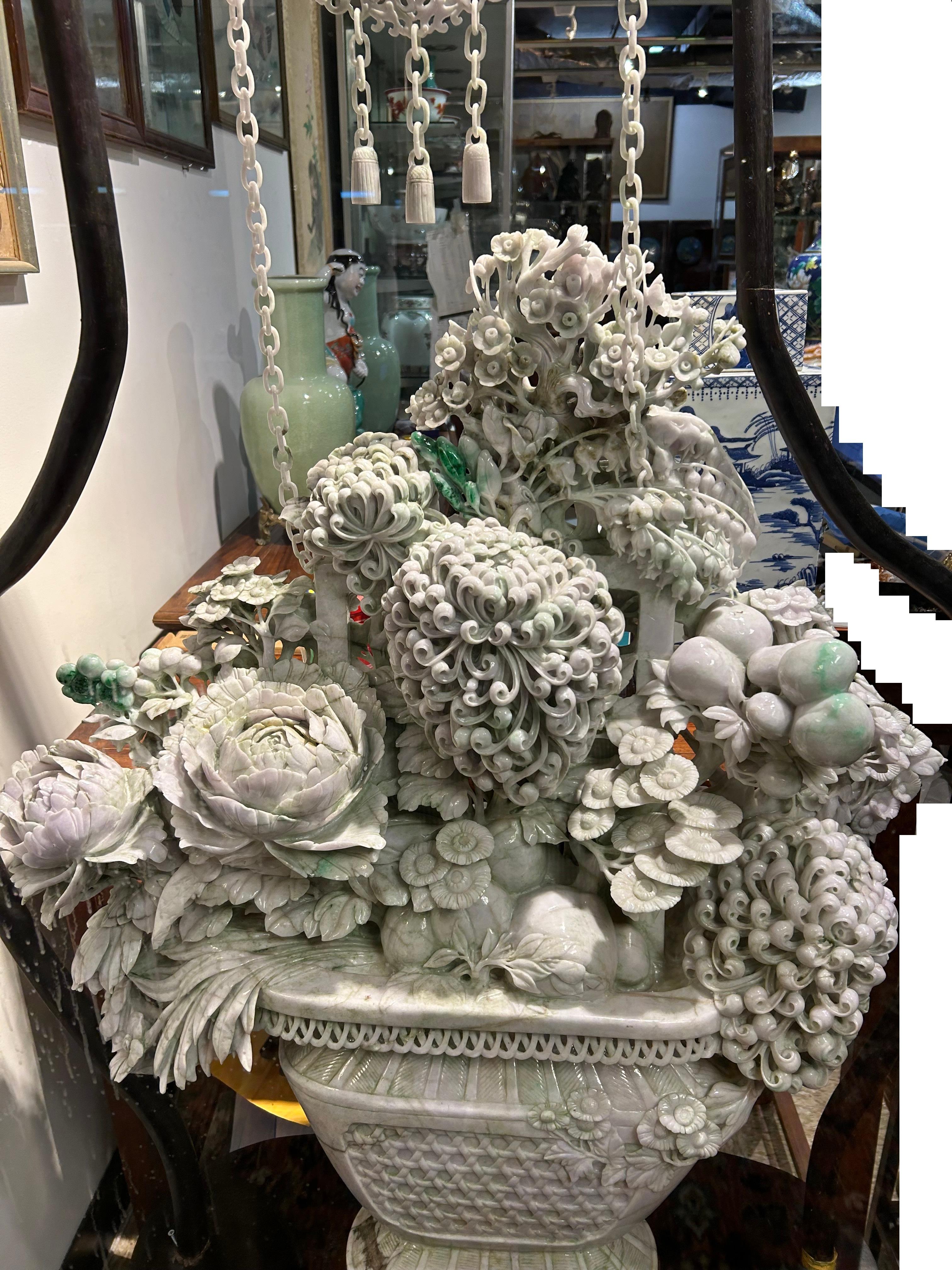 The flower basket (not including the jade chains and connecting jade accessories) is carved from a single massive piece of jade. The jade itself has inclusions and veins, which are NOT to be confused with repairs. The jade itself also has apple