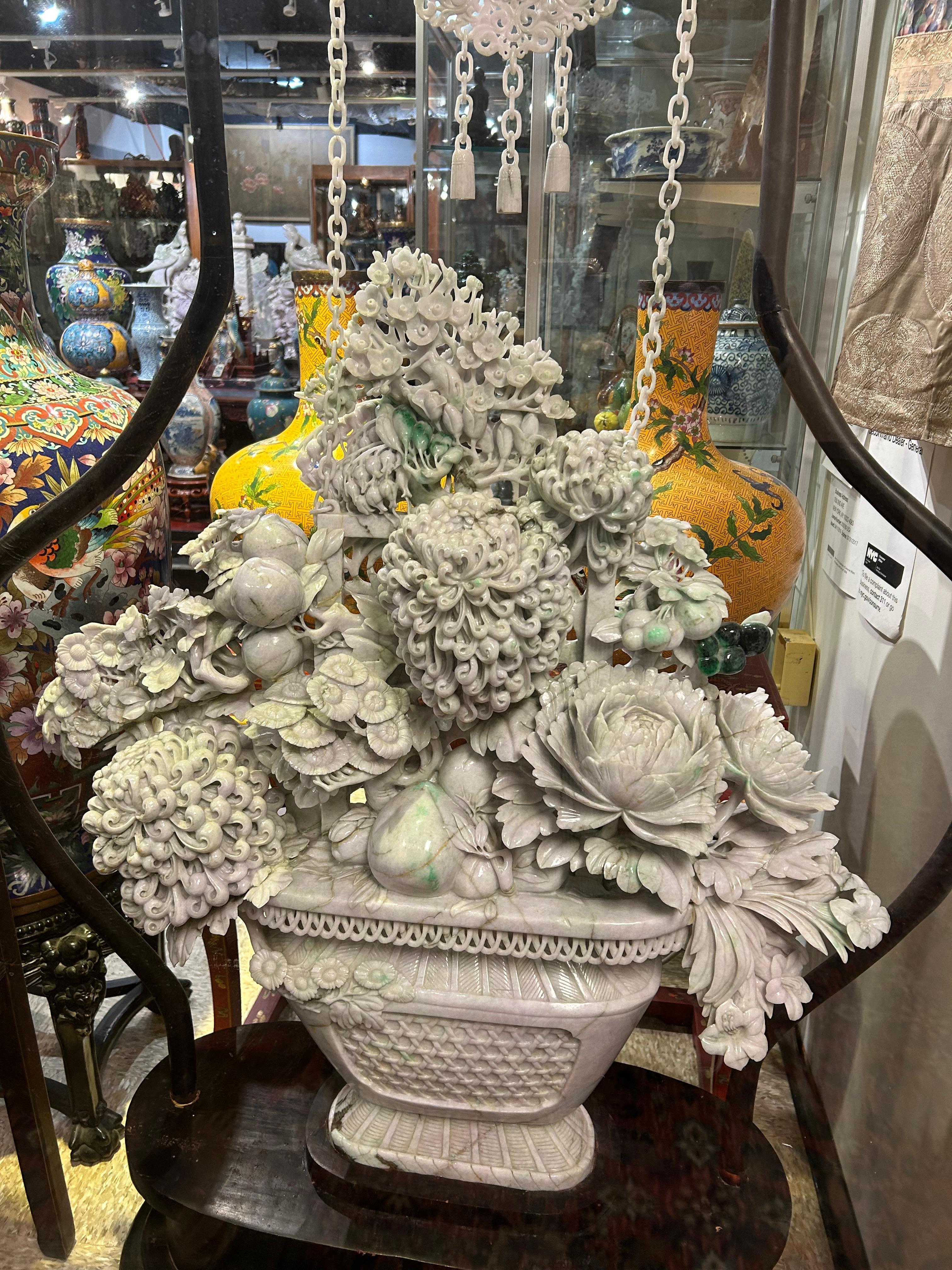 The flower basket (not including the jade chains and connecting jade accessories) is carved from a single massive piece of jade. The jade itself has inclusions and veins, which are NOT to be confused with repairs. The jade itself also has apple