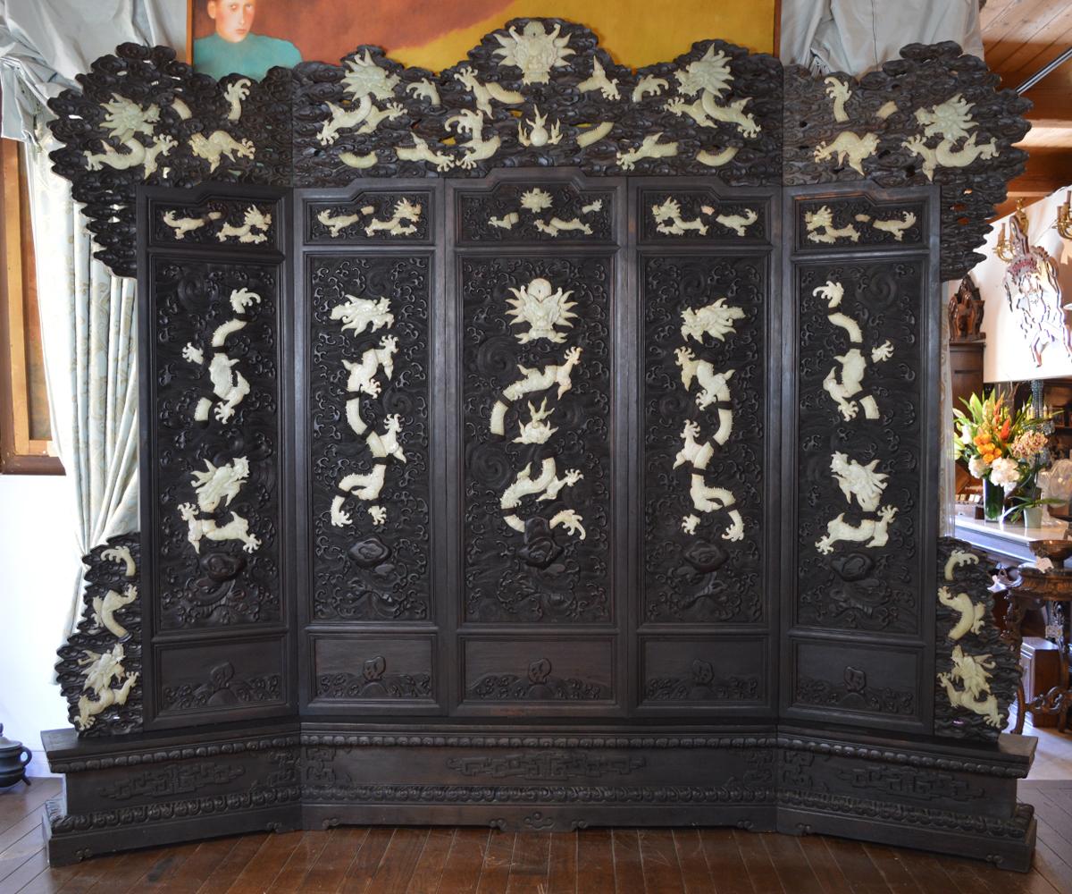 Rarely is a Chinese room size screen or room divider available with the size, quality and quantity of jade incorporated as found in this screen. The screen or divider features the ever important dragons as they fly among the intricately carved