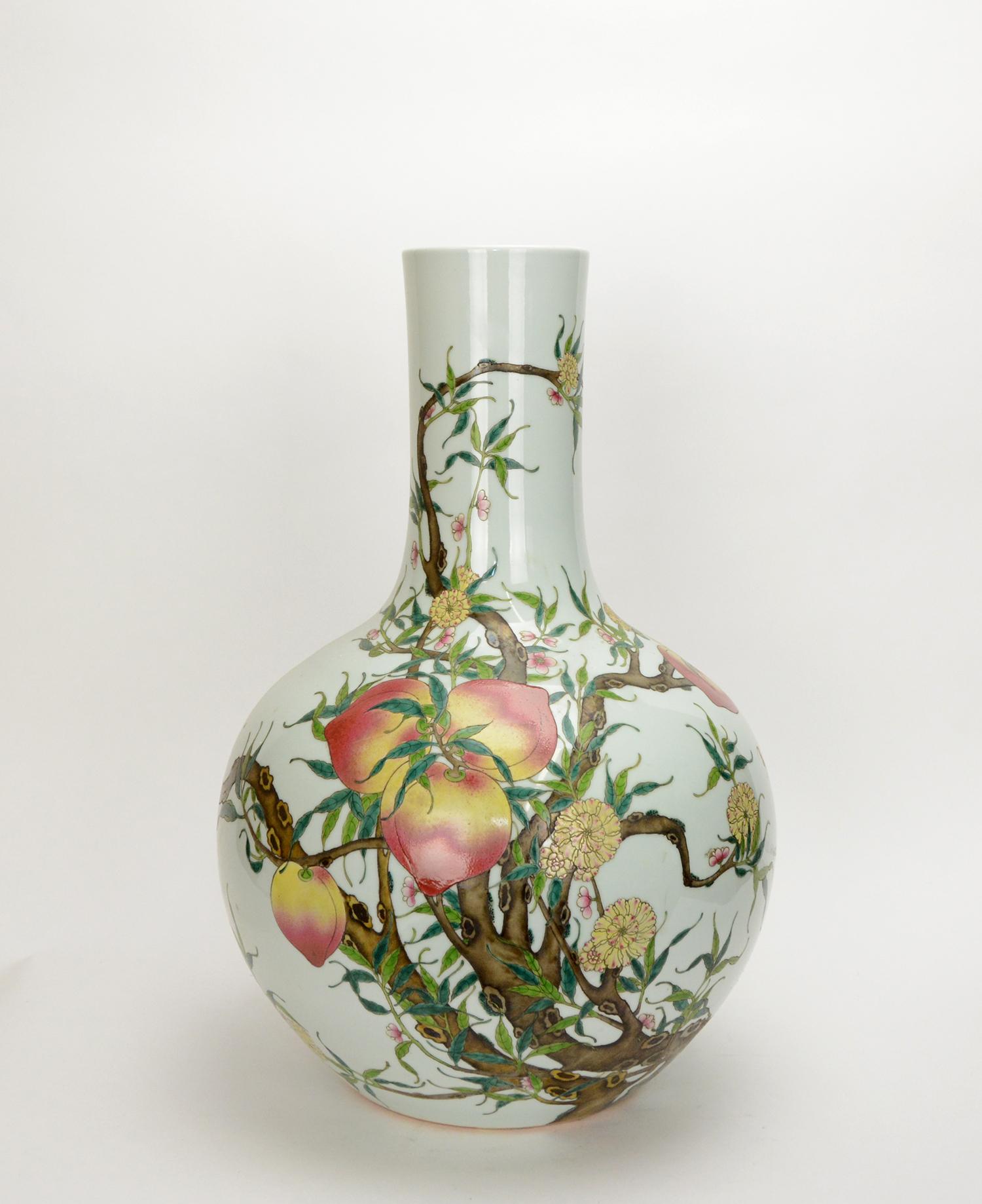 A massive hand painted Chinese porcelain vase with colorful Famille Rose or color enamel peach tree. A fine example of Chinese Qing Qianlong style vase. Peach represents longevity in Chinese culture and you can also find some bats around the