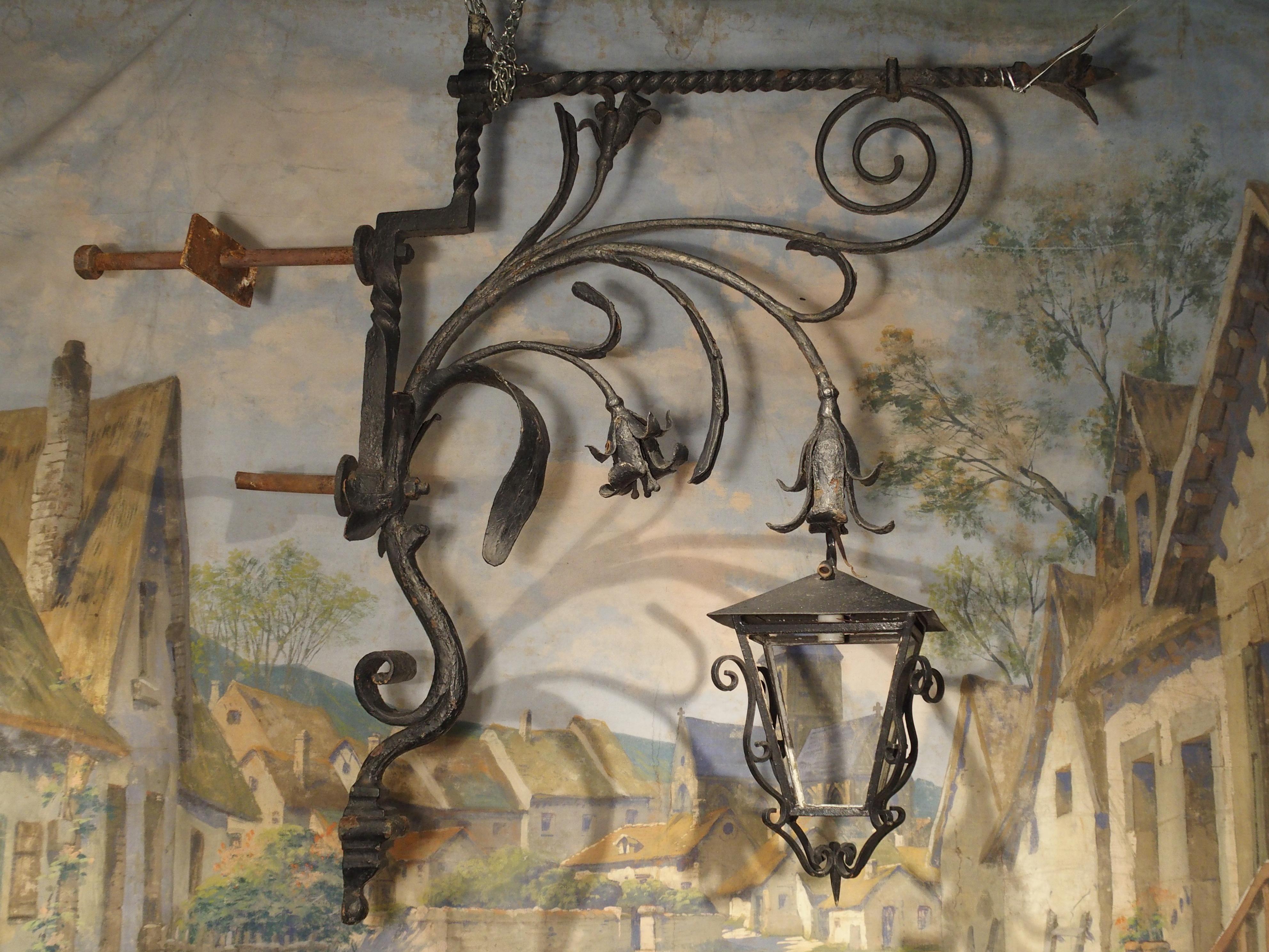 This stunning hand-forged, painted iron lantern holder dates to circa early 18th century and was once mounted to a Castle in the Wallonia region of Belgium. The height is over 6.5 feet and, including bolts, it is roughly 90 inches long (7.5 feet)!