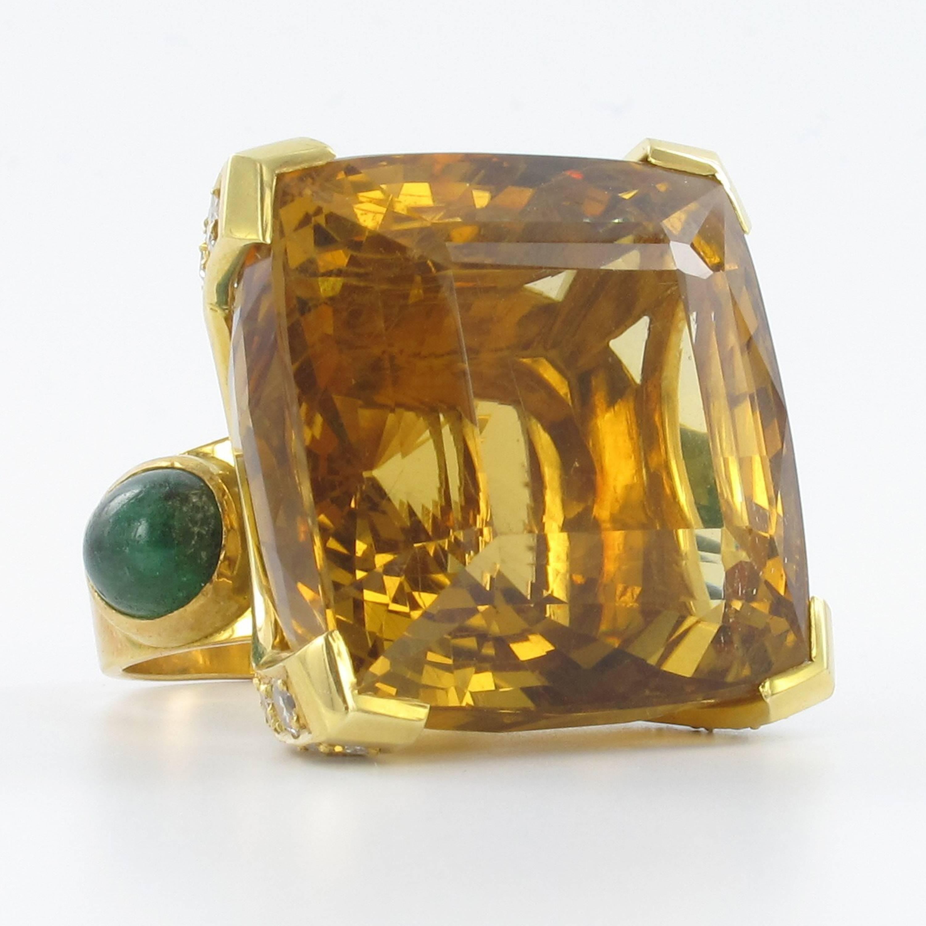 Huge honey colored Citrine ring in yellow gold 750. The citrine with an estimated weight of 80 ct measures approx. 27 x 27 mm. The four prongs are set with 24 single cut round diamonds of approximate 1.44 ct. Additionally decorated with two opaque