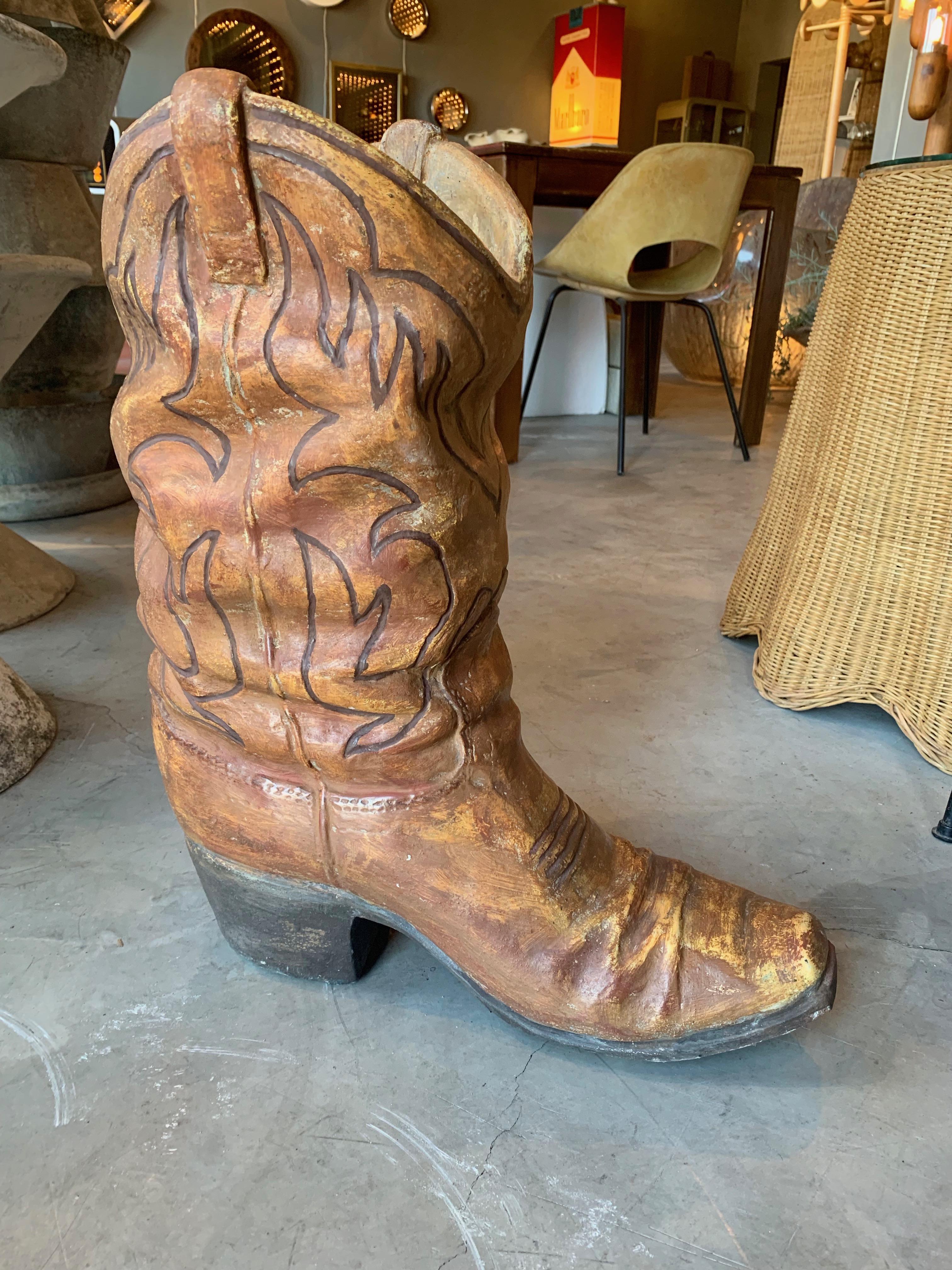 Massive concrete planter in the shape of a cowboy boot. Extremely heavy and sturdy. Drainage hold inside. Great coloring and condition. Cool sculptural object for indoors or outside.





  