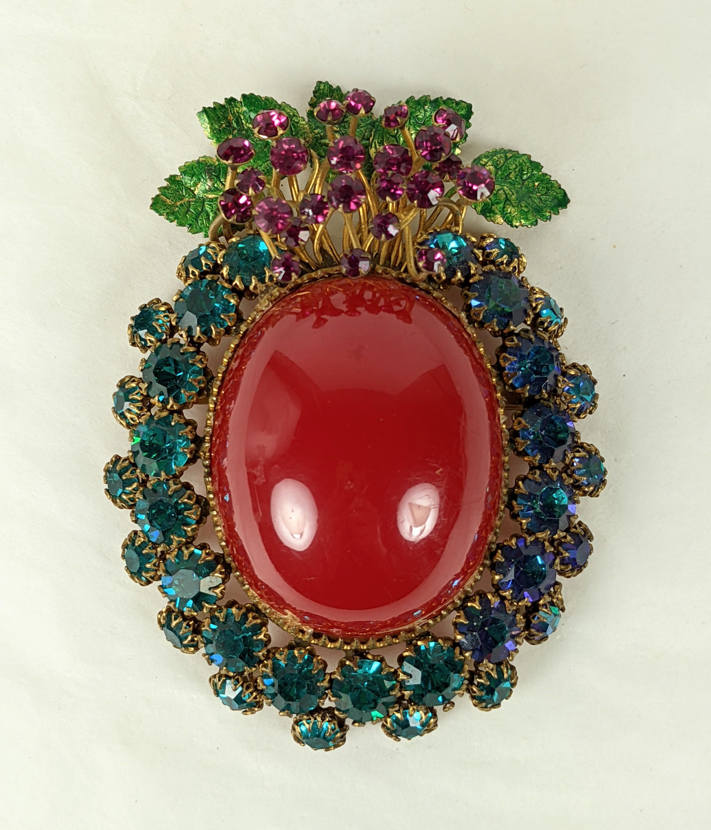 Incredible and rare Massive Countess Cis Floral Brooch from the 1950's France. Enormous rasberry bakelite cabochon is decorated with prong set Swarovski crystals in tones of deep turquoise with a spray of Fuschia crystals emanated from enameled