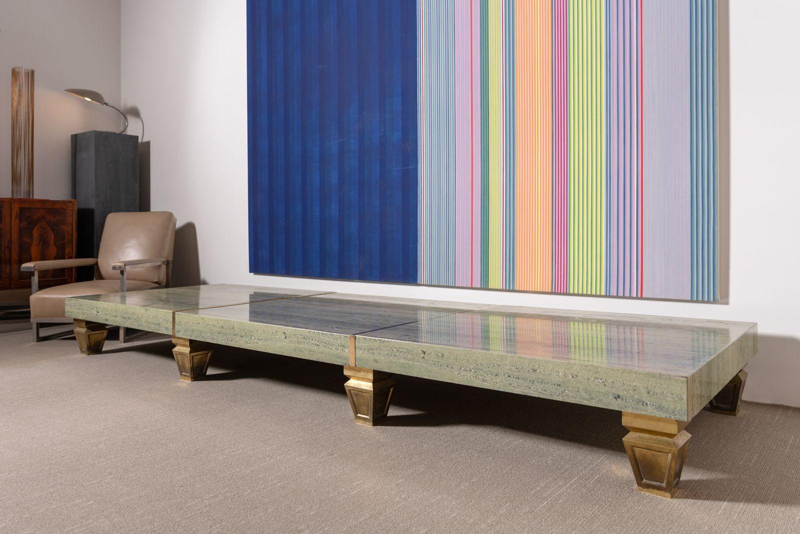 A truly unique piece, this ten-foot coffee table was custom-made for the flagship Neiman Marcus store in historic downtown Dallas. Crafted from a single slab of striking green travertine, it features polished brass legs and an elegant minimalist
