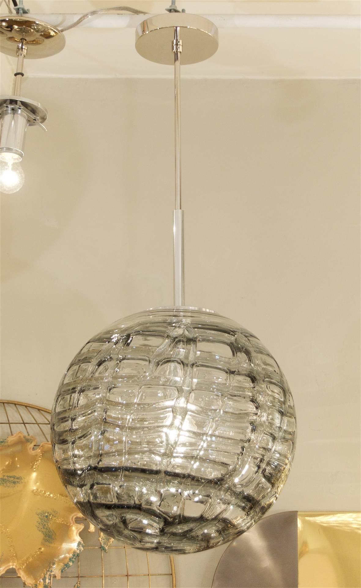 Fantastic Doria pendant will complement all decors. Heavy textured wave surface glass, smoke tones variegated from clear. Chrome hardware. 

Takes a single medium base bulb up to 100 watts, new wiring.

Measure: Length of drop rod can be