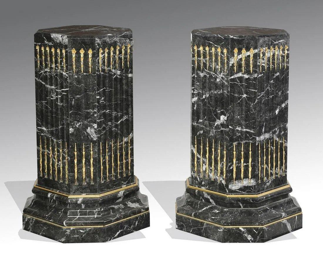 Pair of massive Edwardian style bronze mounted Portoro marble pedestals, each of octagonal form, having fluted sides mounted with gilt bronze laurel garlands, terminating to a plinth base. England, circa 1900.
Dimensions: Height 39