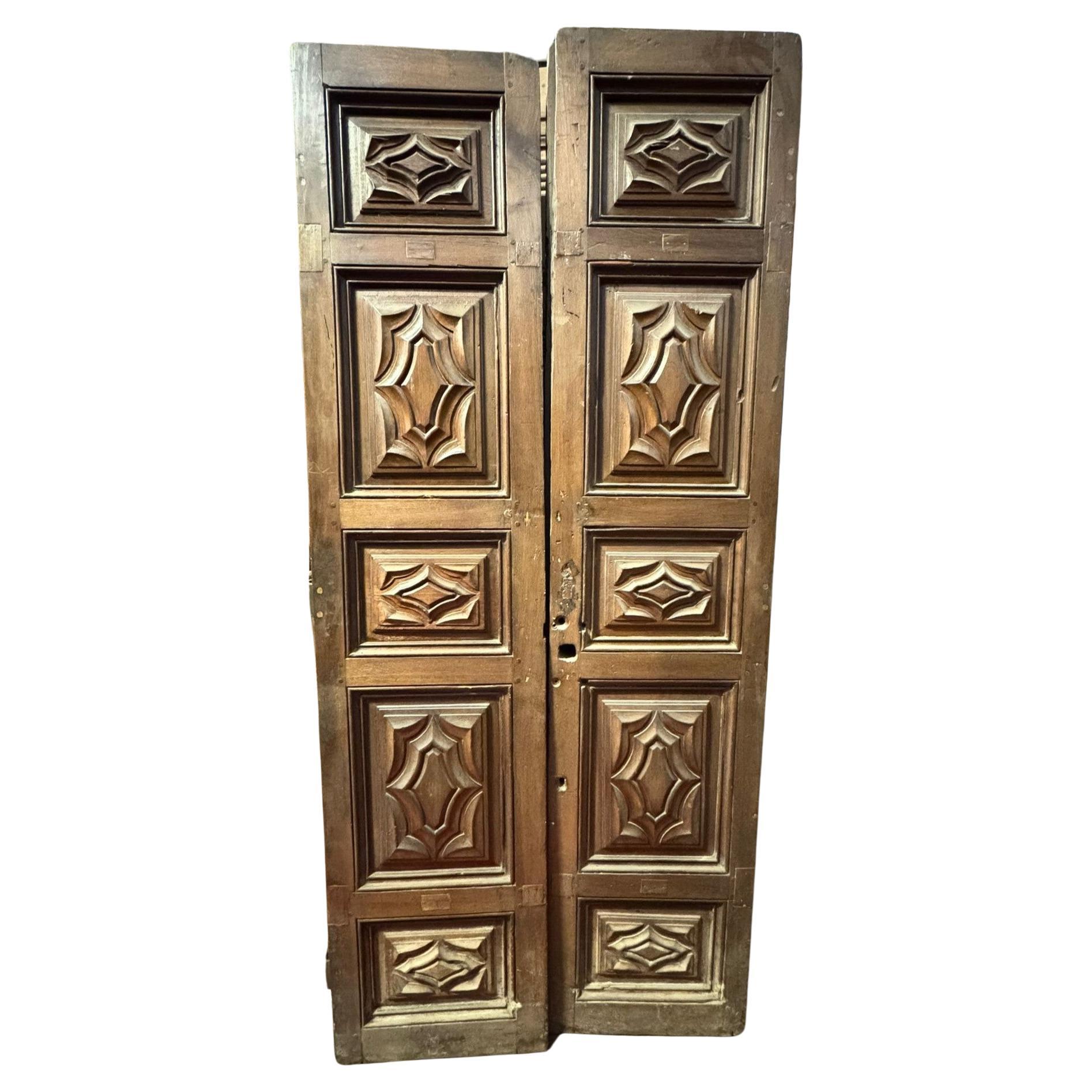 Massive entrance door, carved in walnut wood, Italy