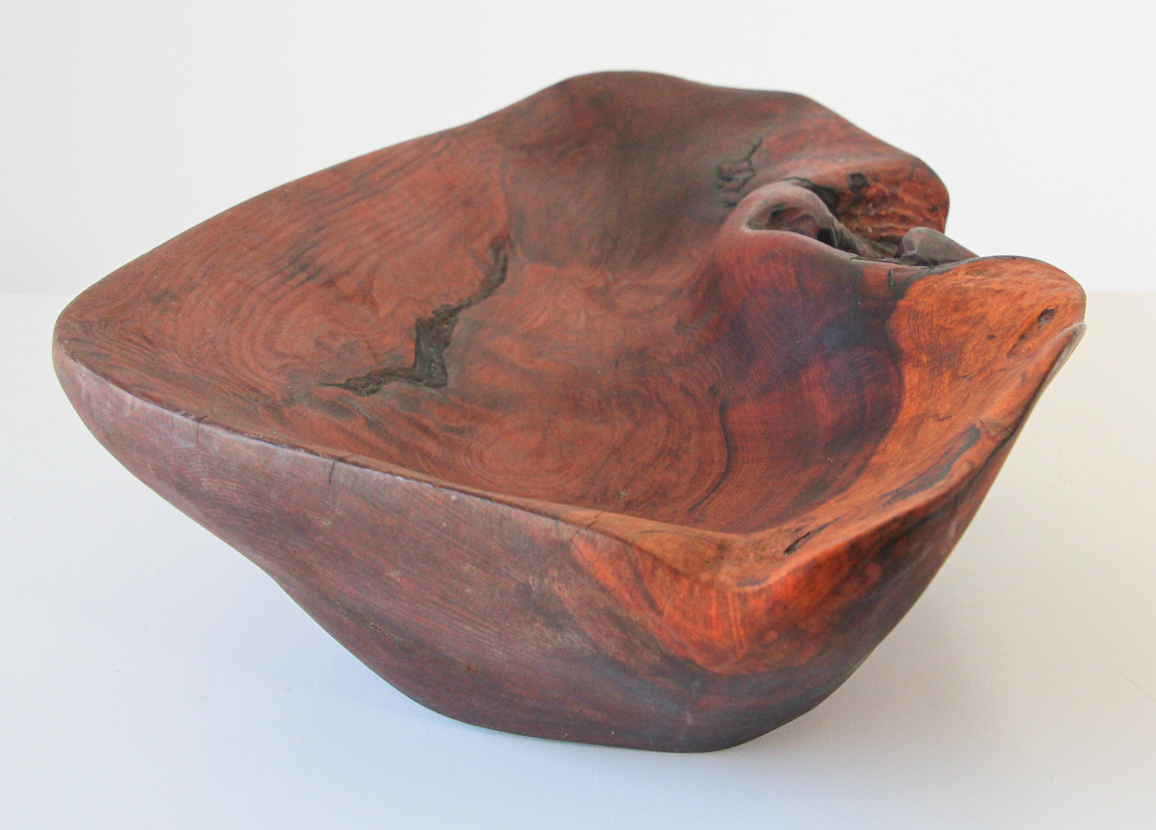Exceptionally crafted and large sculptural Brutalist freeform burl wood centerpiece bowl.
Hand carved from a unique piece of cherry burl wood. A burl occurs naturally through tree growth where the grain has grown in a deformed manner, usually due