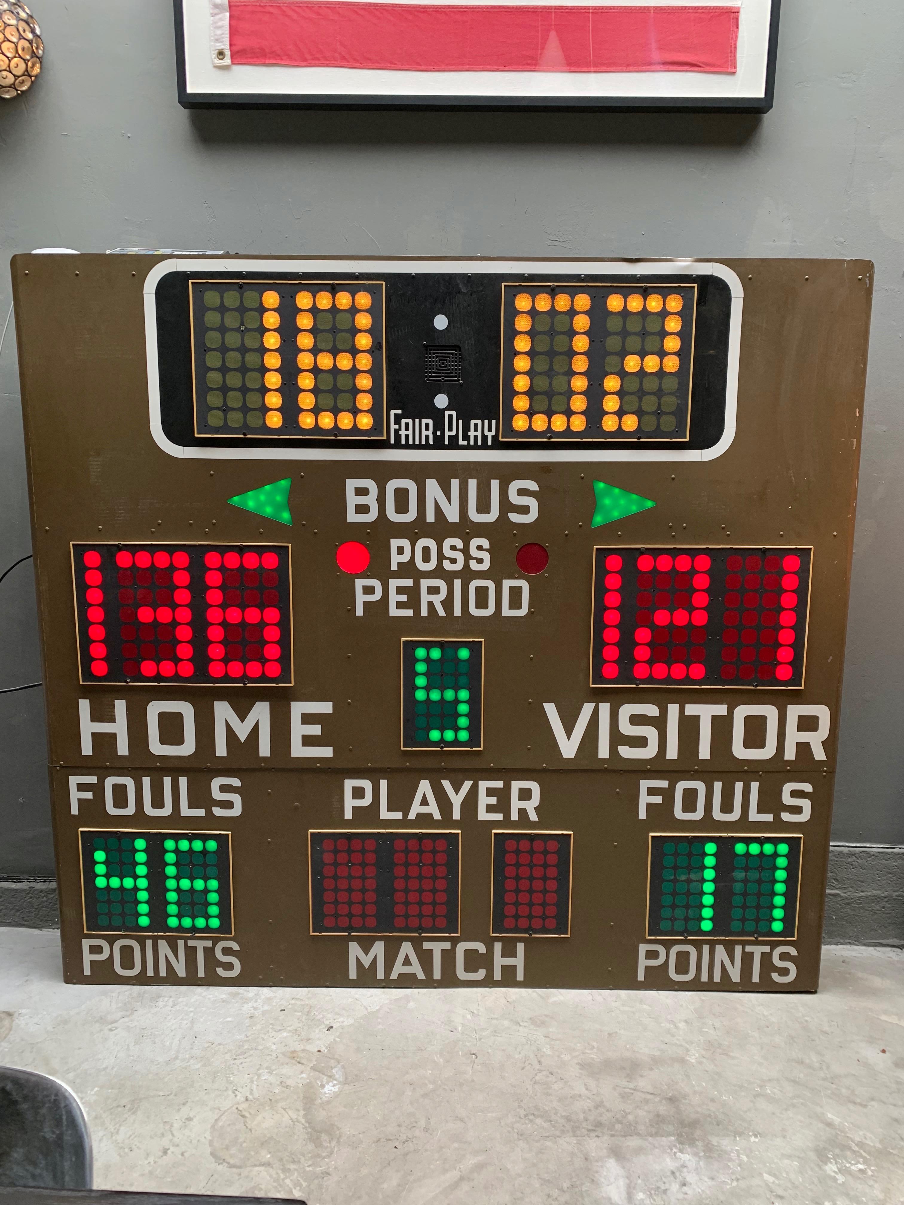Massive vintage basketball scoreboard by Fair Play in the 1970s. In perfect working order with controller to adjust score, running shot clock etc. Working Horn. Very fun piece of art for your home or commercial space. Taken down from a school