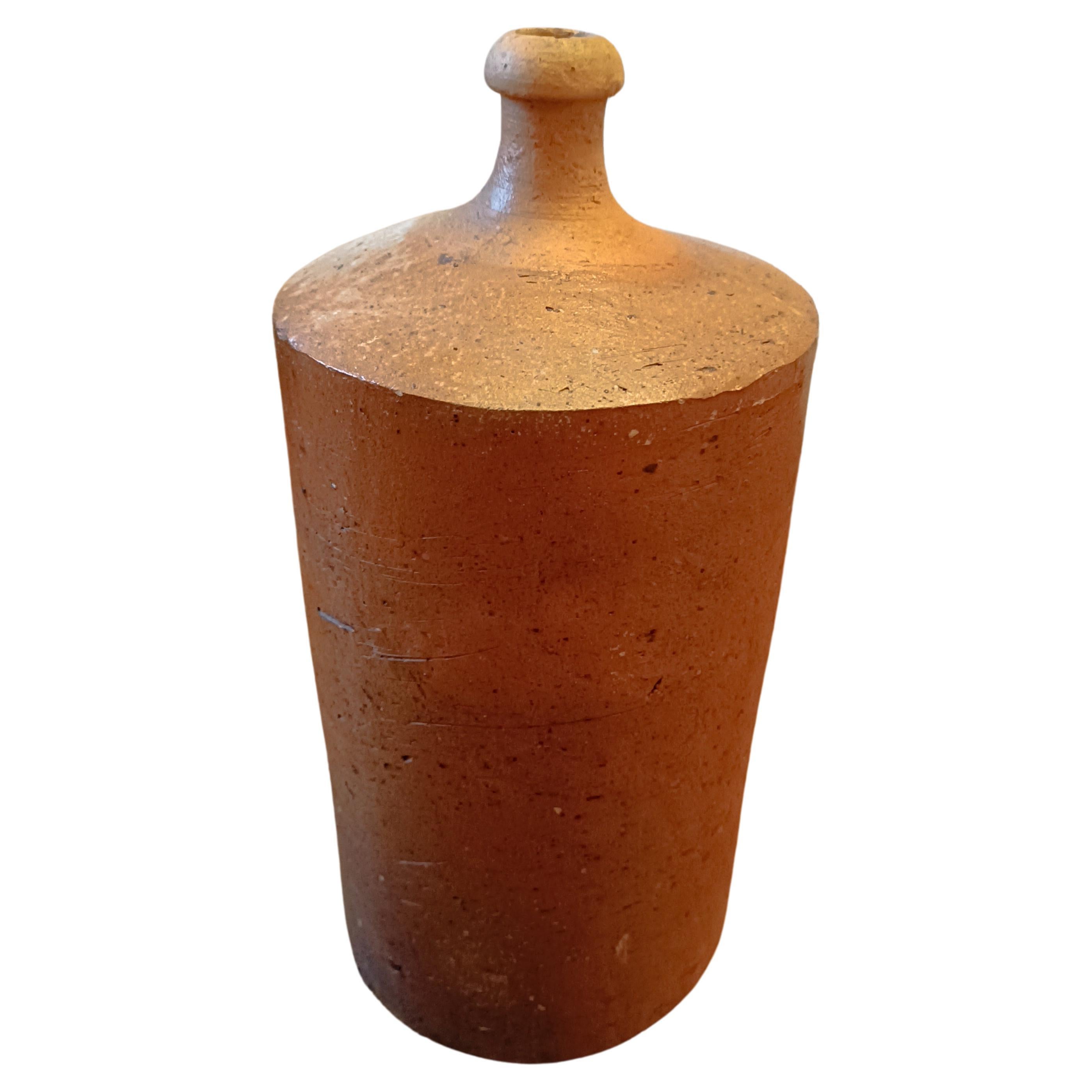 Massive french earthenware bottle, late 19th century - terracotta bottle

Superb old terracotta bottle.
Its circular shape and rough texture make it a beautiful and original piece.
It is in goodcondition.

Its height is 37 cm. Its diameter is 18
