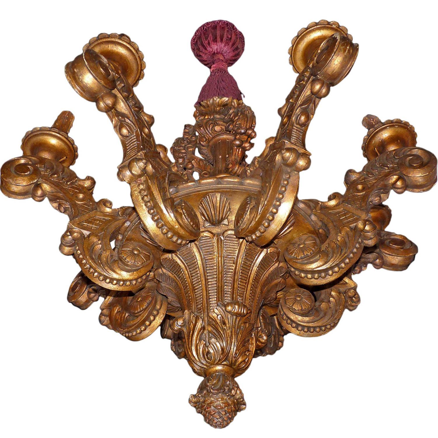 Massive wood carved gold leaf Baroque 8-light giltwood chandelier. The scrolled arms have foliate embellishment pincered to a gadrooned central knop. Adorned with foliate baluster stem above and fruiting drop-finial below.

Measures:
Diameter 40 in/