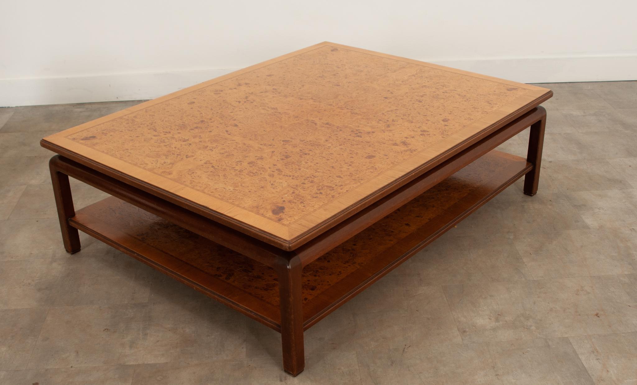 This incredible coffee table will make an impact in any space. The top showcases the fantastic bookmatched burl elm wood grain. The lower shelf is just as large as the top and slightly darker- it allows for a nice amount of hidden, but accessible