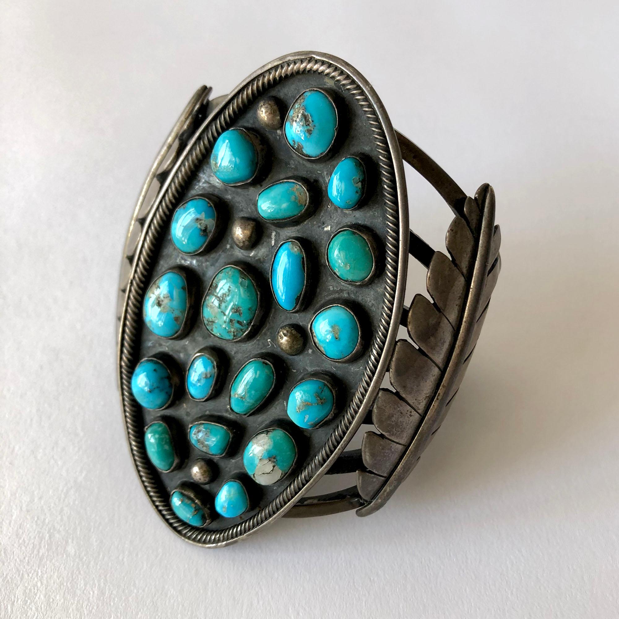 Large scale sterling silver and turquoise Navajo cuff bracelet with leaf design, circa 1960's.  Bracelet has a 7 3/4