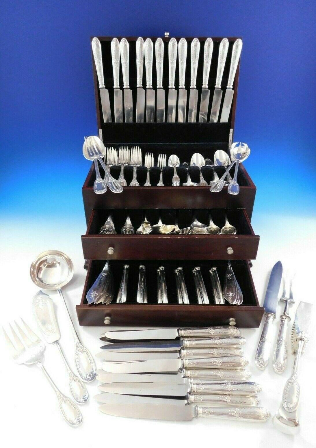 Monumental Empire-style 800 Silver German Flatware set - 168 pieces. The pieces have a classic leaf, shell, and flower handle design and on the reverse angel wings and a torch at the base of the handle. This set includes:

24 large continental size