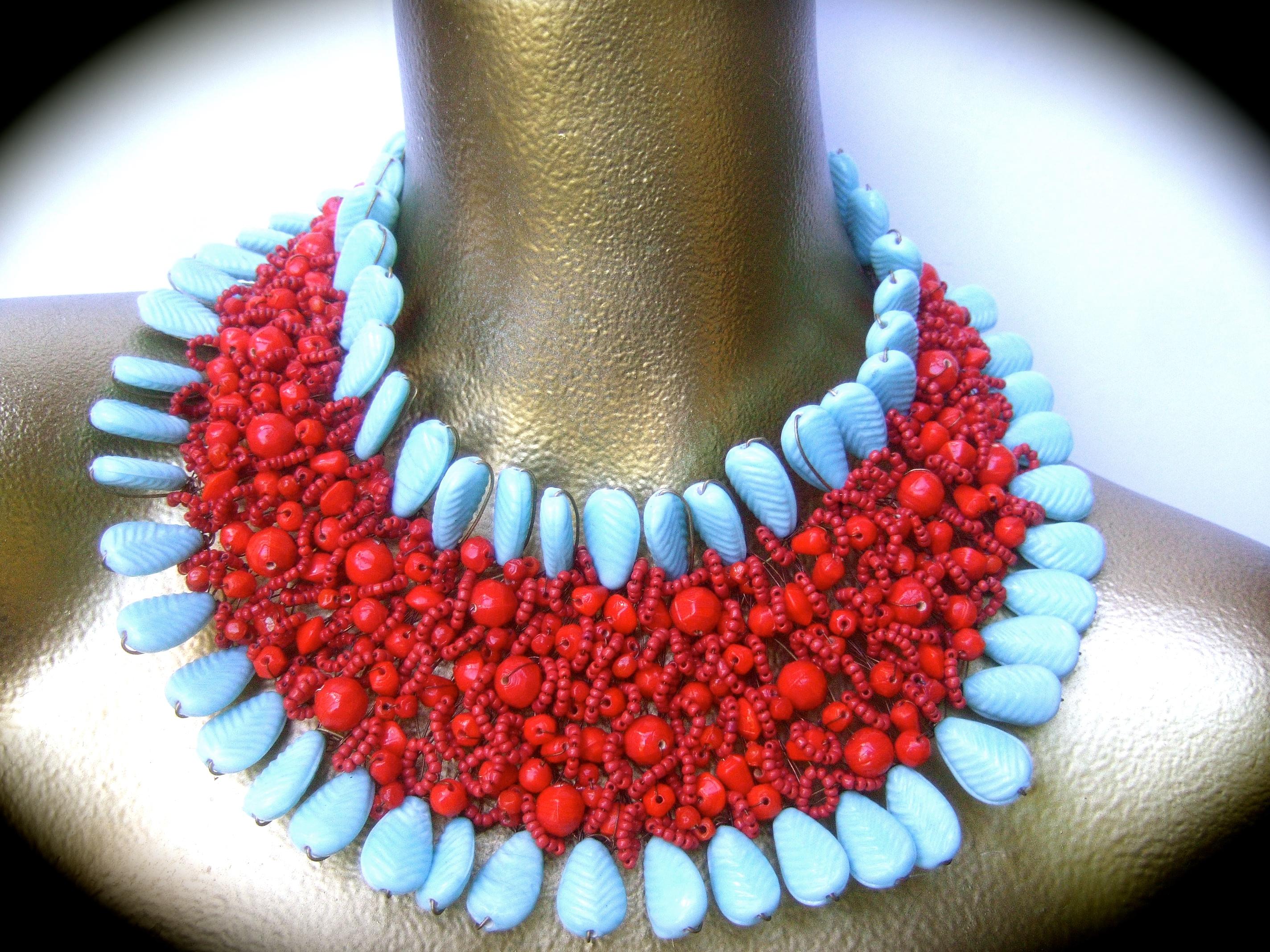 Massive glass beaded handmade artisan choker bib collar necklace 21st c 
The bold avant-garde large scale wide choker bib necklace is comprised of a collection of pale aqua blue glass stones that frames the border edges. The collection of