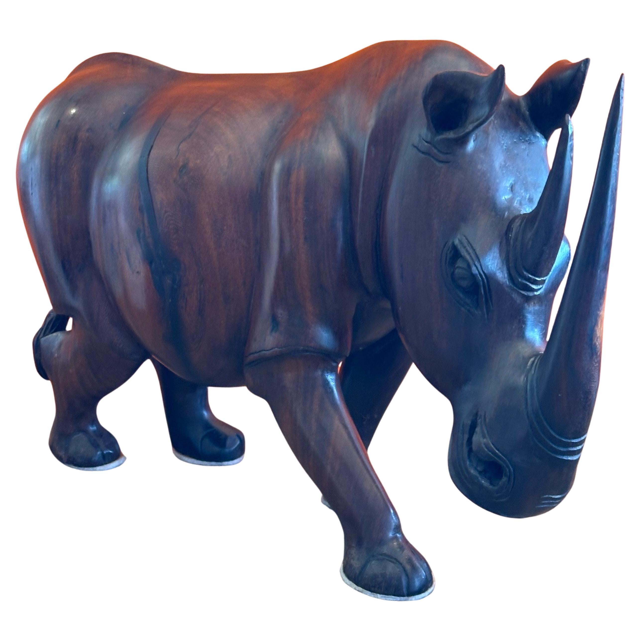 Massive incredibly detailed hand-carved white rhino / rhinoceros sculpture, circa 1970s. The intricacy of the piece is amazing and it appears to be hand carved from a hardwood (possibly rosewood or zebra wood). The sculpture is in very good