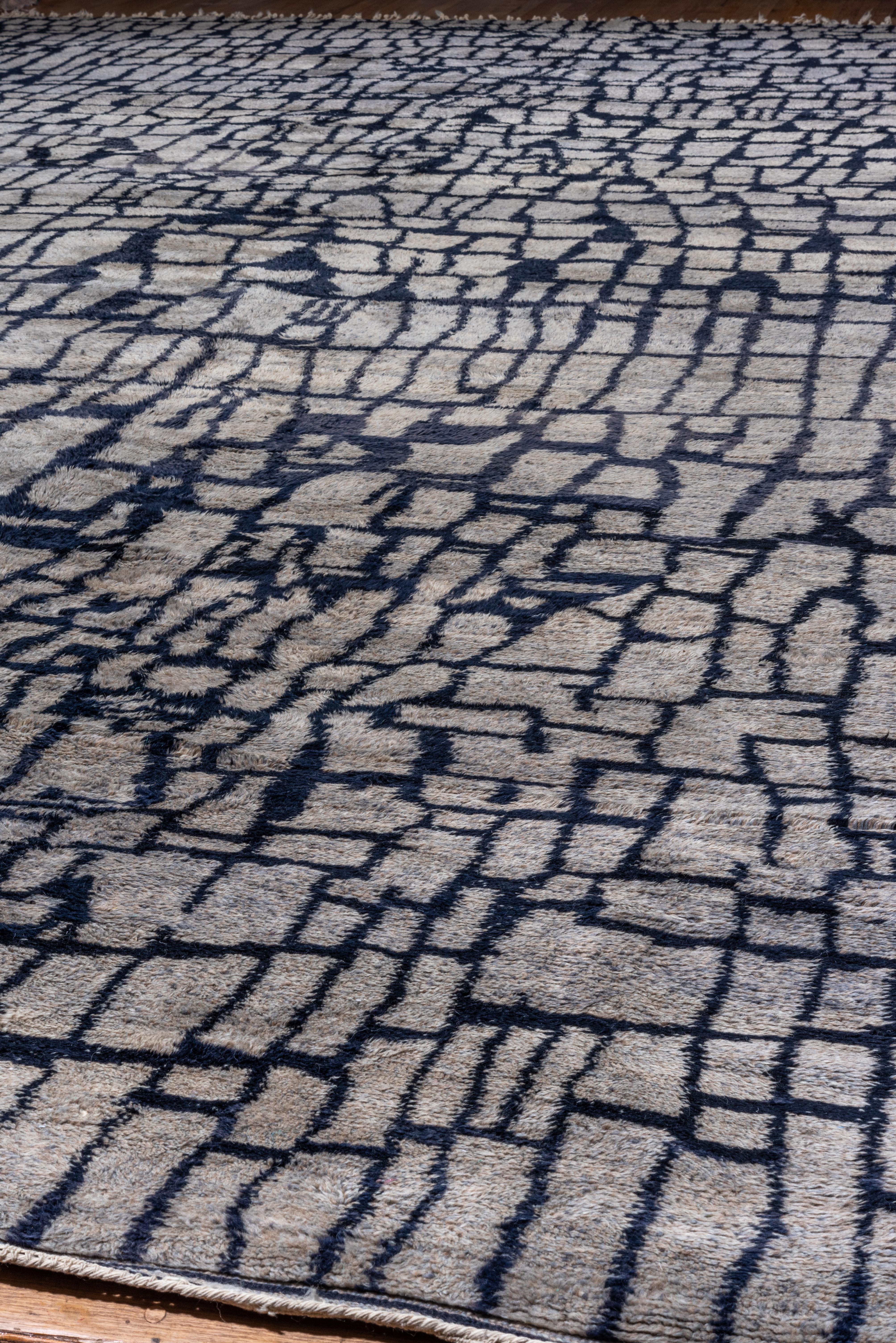 Beautiful new production Moroccan carpet with designs inspired off of vintage Moroccan motifs. Gray & Navy tones. A beautiful piece for a large room!.