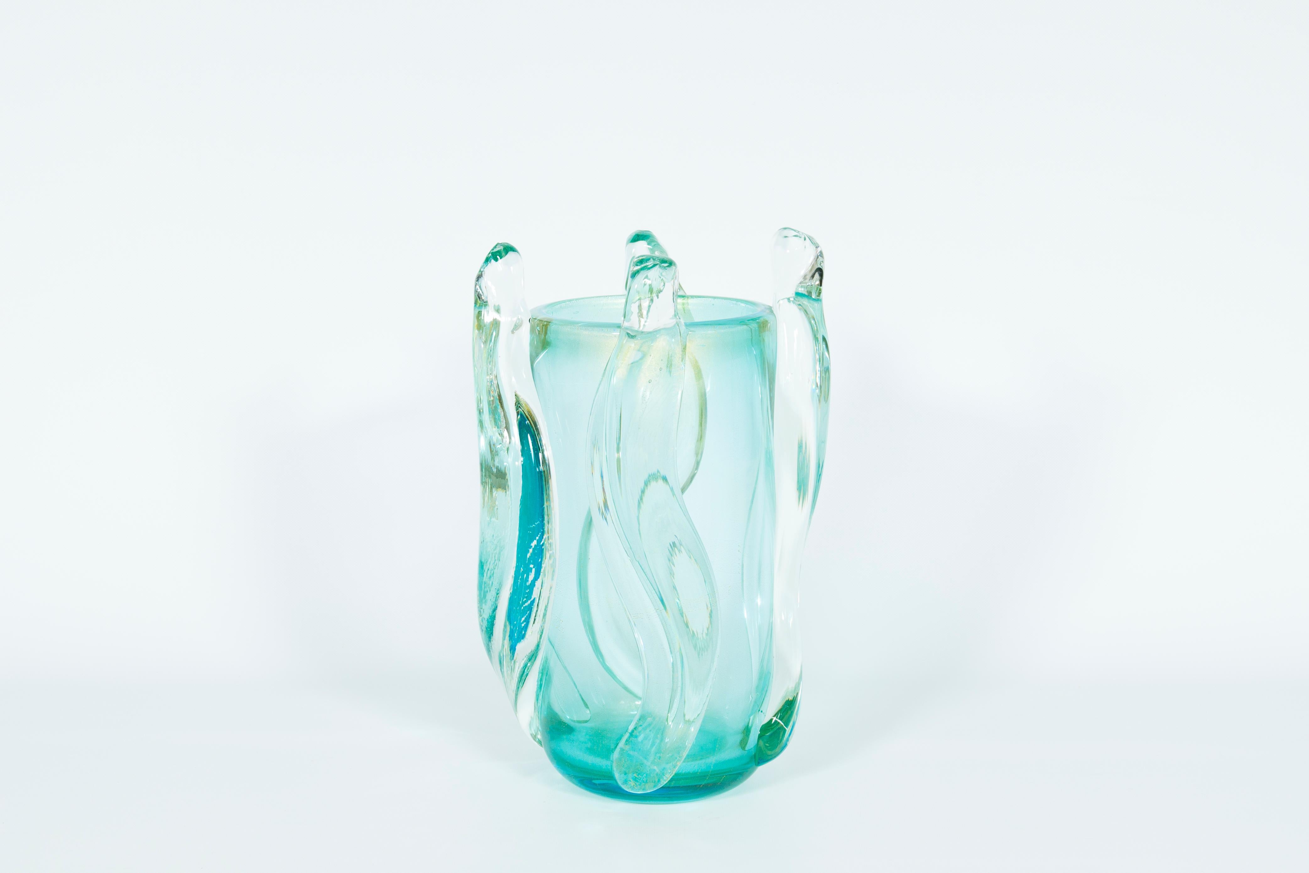 Grandiose Ice toned Murano Vase with Fluid sculptured Curves Contemporary Italy. This magnificent vase, crafted entirely by hand in Murano glass, is a testament to the artistry and craftsmanship of Italian glassmaking. Its thick, translucent