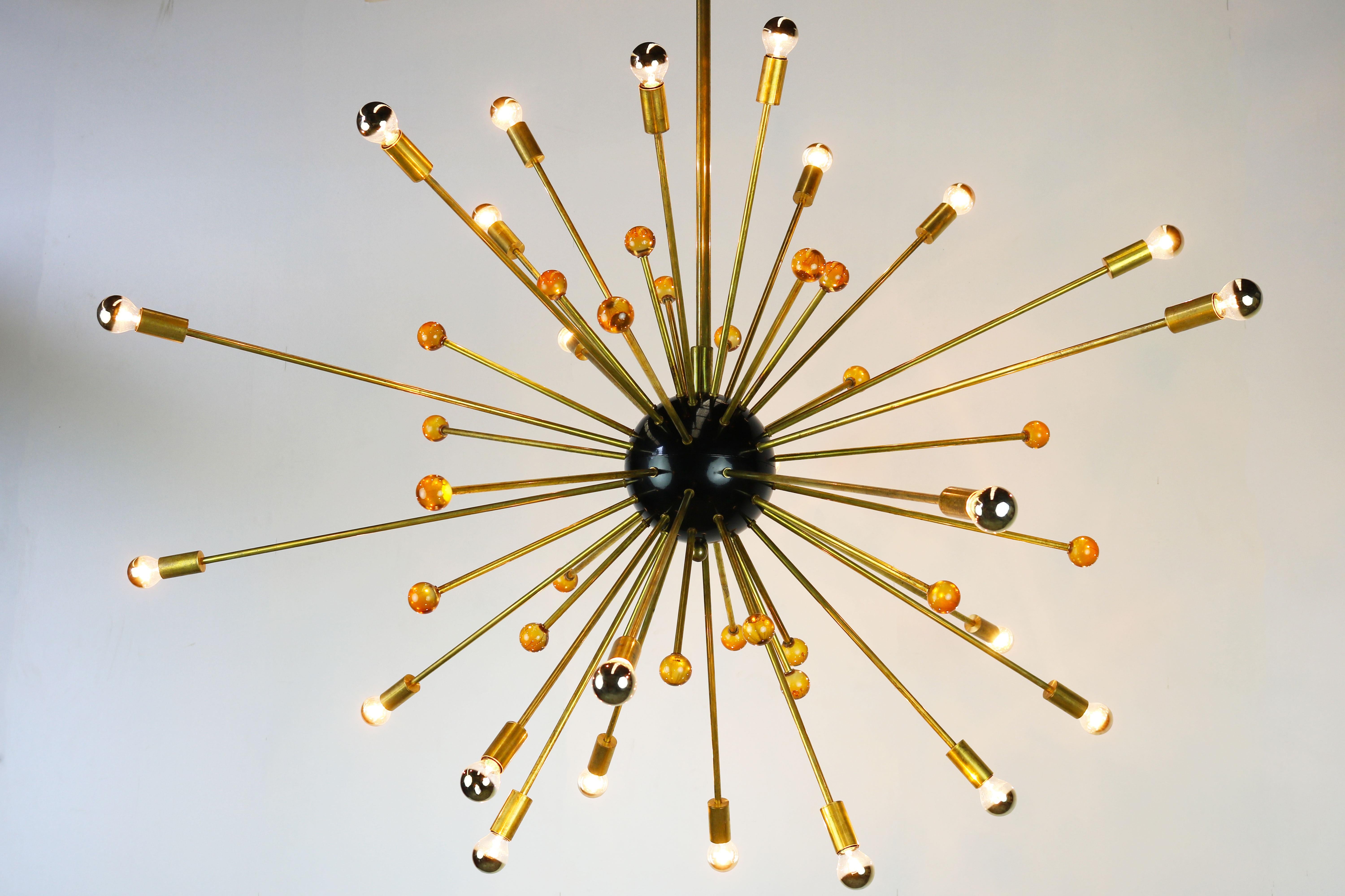 Massive Sputnik chandelier Stilnovo with a diameter of 150 cm from the 1950s. The chandelier has 48 brass rods, 24 rods have a light socket and the other 24 rods have a orange glass sphere. Its Minimalistic shape make it great for any midcentury or