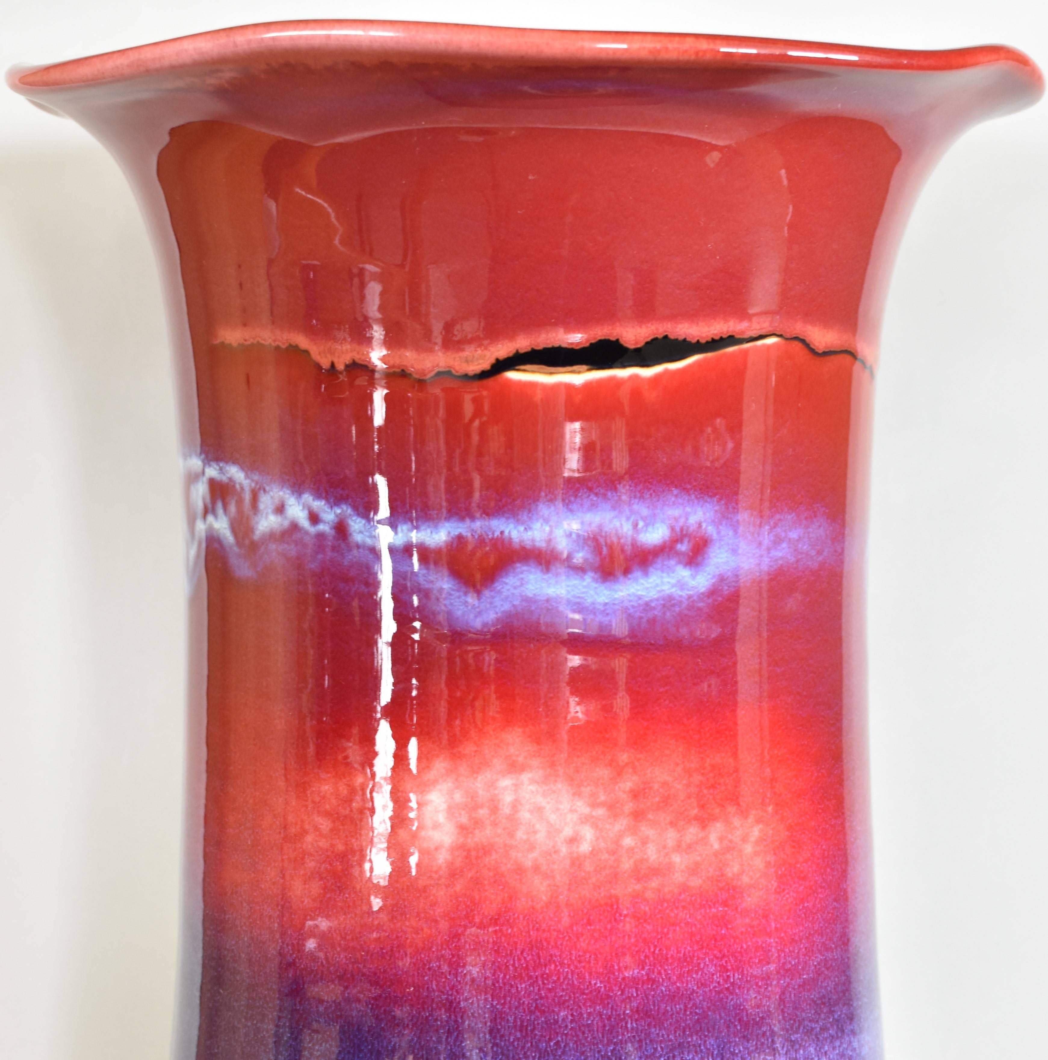 Mesmerizing highly collectible massive decorative porcelain vase, hand-glazed in the artist's signature vivid red and purple/blue on a stunning cylinder shape body. It is a nationally exhibited masterpiece from the extraordinary signature Galaxy