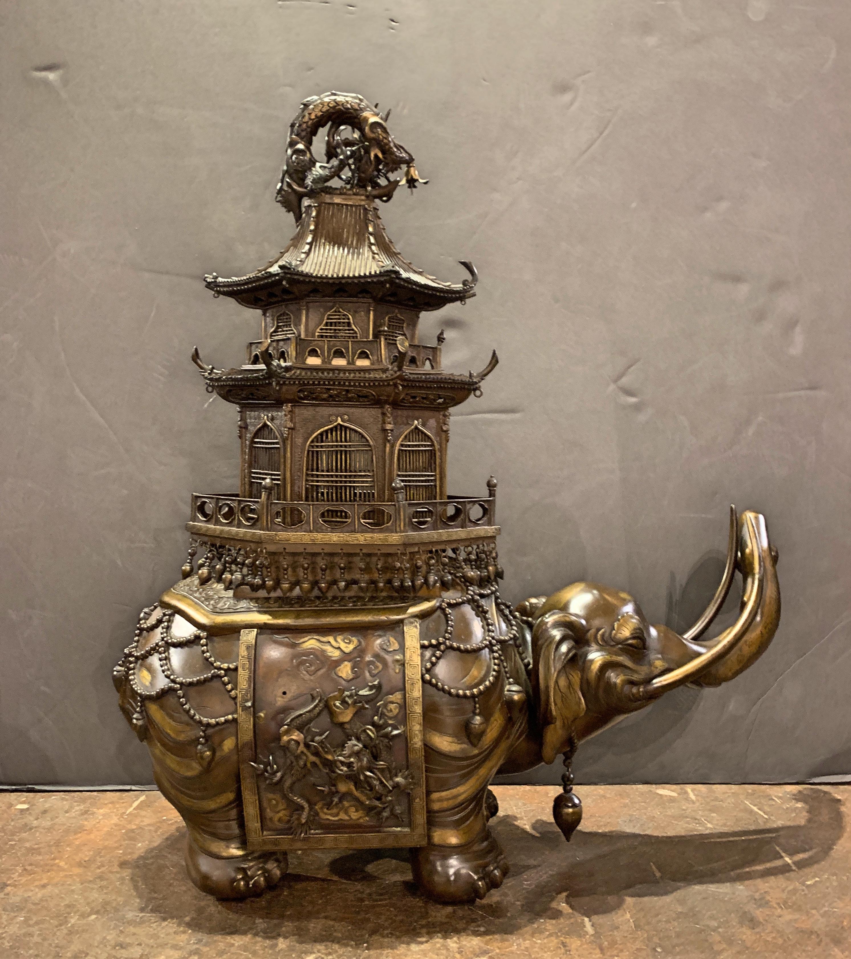 A large and impressive Japanese cast and parcel gilt bronze koro (incense burner) in the form of a caparisoned elephant carrying a pagoda on its back, Meiji Period, late 19th century, Japan. 

The elephant has been well cast with charming details.