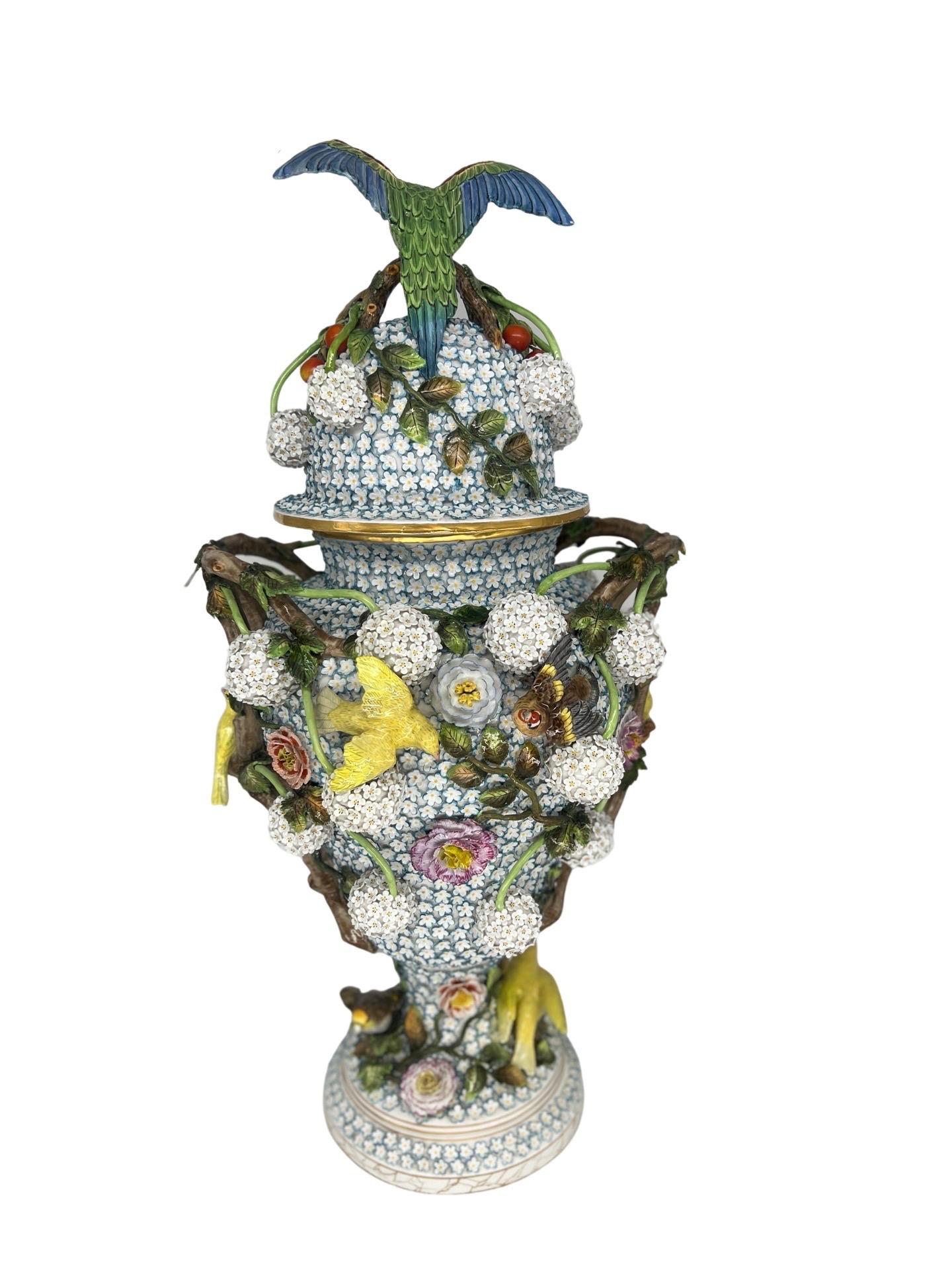 The monumental J.J. Kaendler 1780’s Meissen Schneeballen porcelain lidded urn with bird mounts is an exquisite and rare piece of art that embodies the craftsmanship and beauty of the Meissen porcelain tradition. Standing tall and proud, this urn