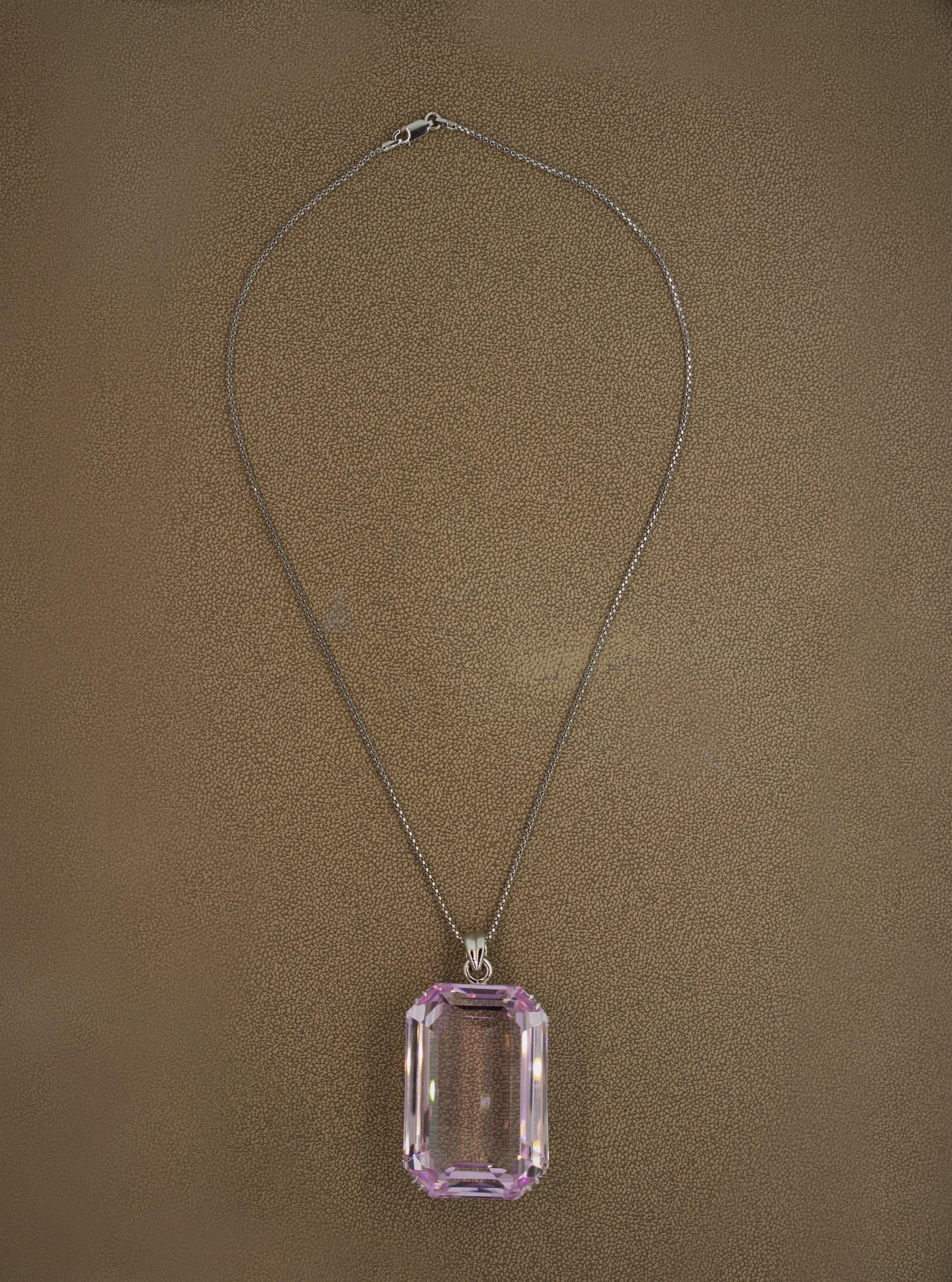 A truly stunning piece. This pendant holds a 312.57 carat kunzite with a bright and vivid pink color. Stones like this are exceedingly rare and hard to come by. It has been set in a custom hand fabricated platinum mounting and comes with a fine