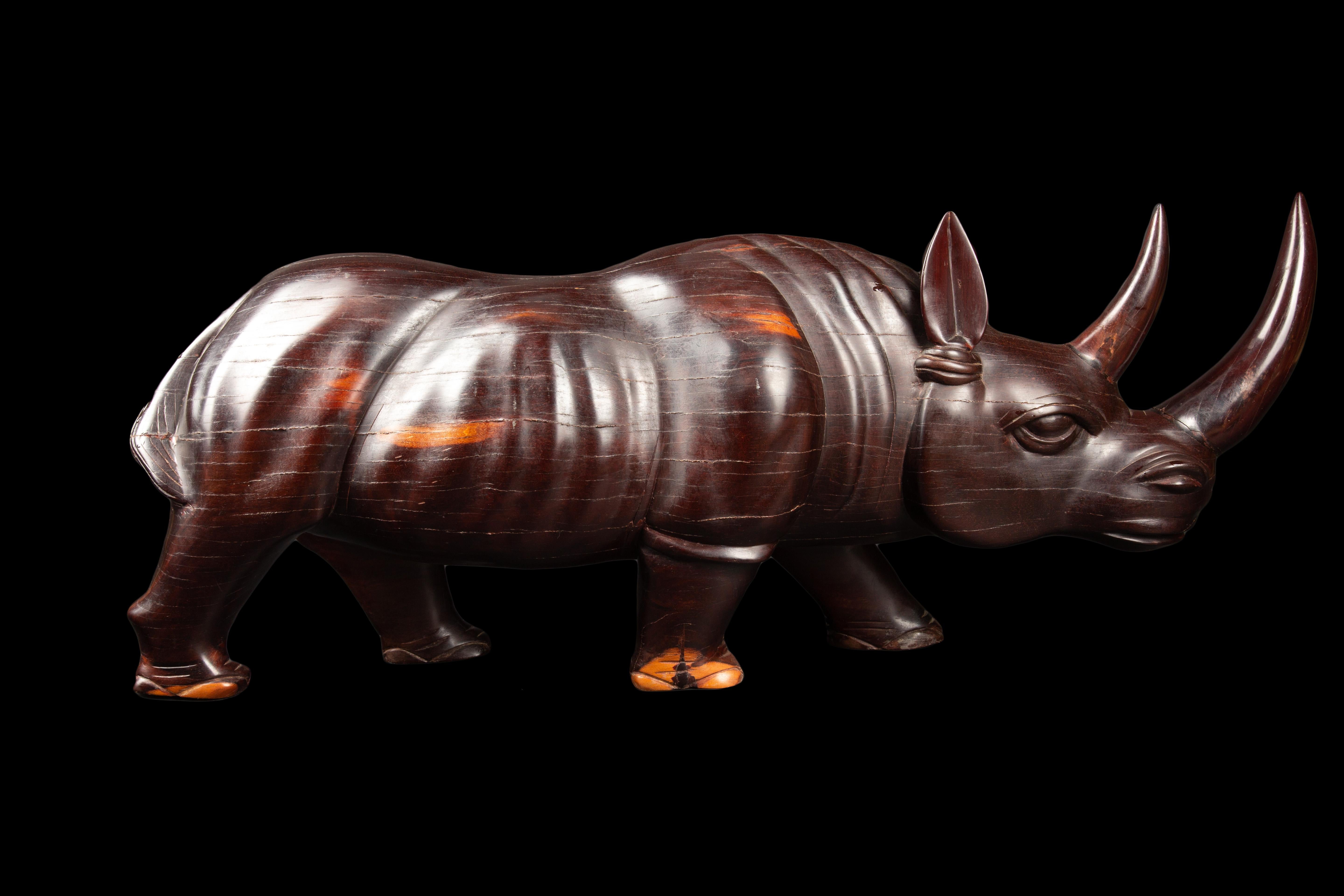 Indulge your senses with the exquisite craftsmanship and timeless elegance of this stunning African Ebony Rhinoceros sculpture. Meticulously hand-carved with utmost precision, this masterpiece showcases the natural beauty and richness of the ebony