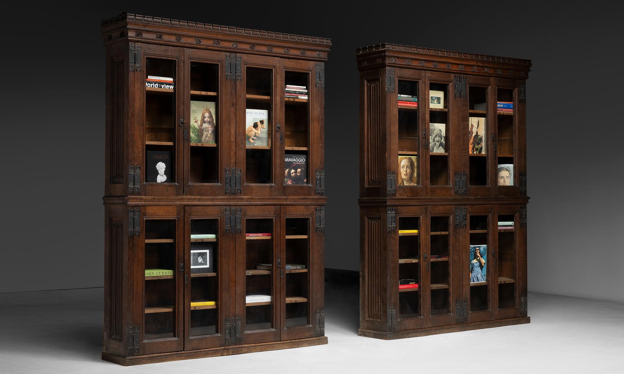 Massive Oak Bookcases

England, 1900

Large oak bookcases with upper and lower sections, each fitted with multiple glass-front doors and metal strap hinges. Carved cornices and panel details.

70”w x 14”d x 96”h

Ref. CASE179