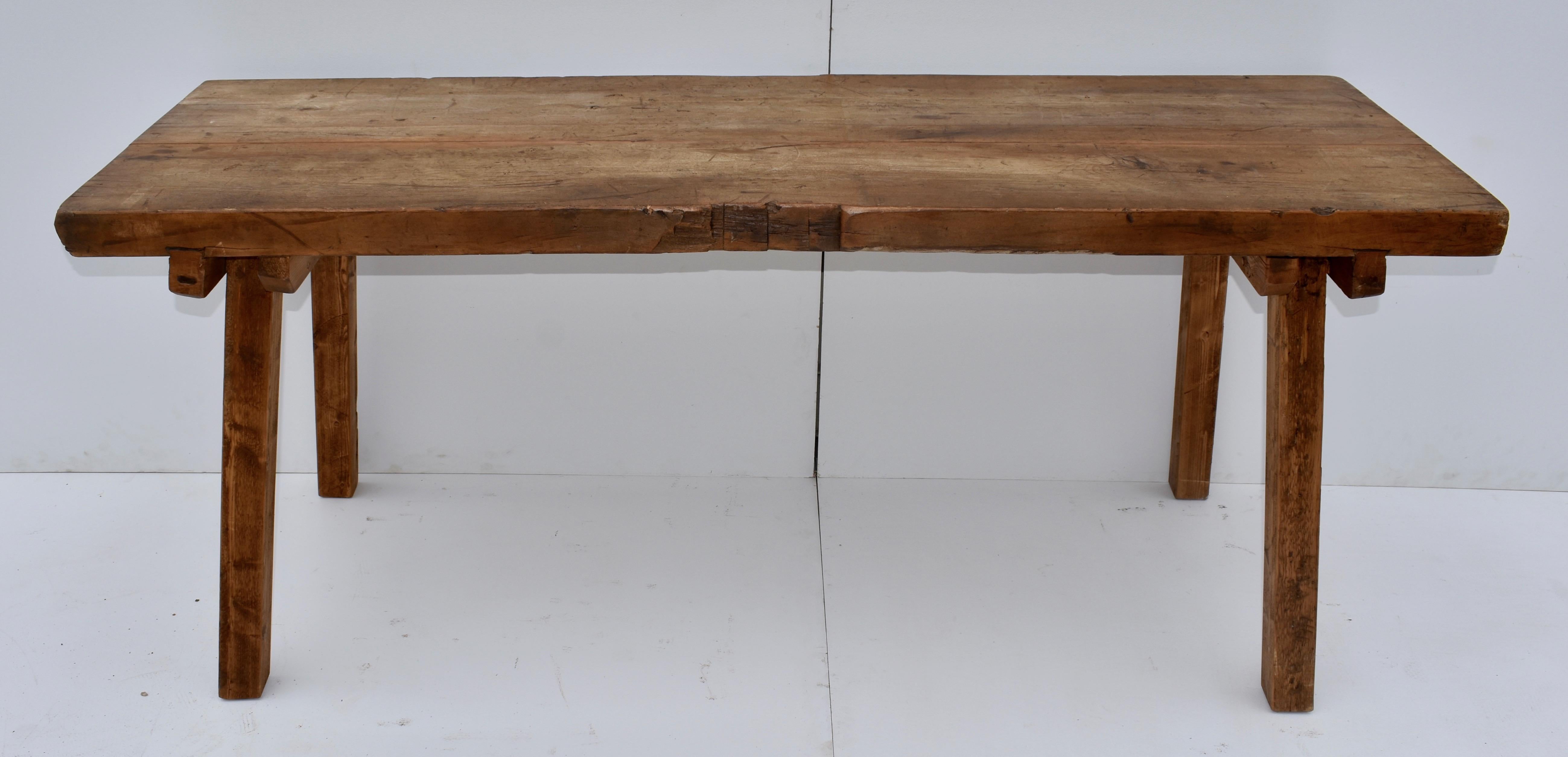 57. 23VJL57 (8242) oak pig bench butcher’s block table, Hungary, circa 1900, 75” L x 26” W x 31.5” H The top of this massive pig bench is made from two oak slabs, over 2.5” thick, tightly splined together. Though well-used, the top is relatively