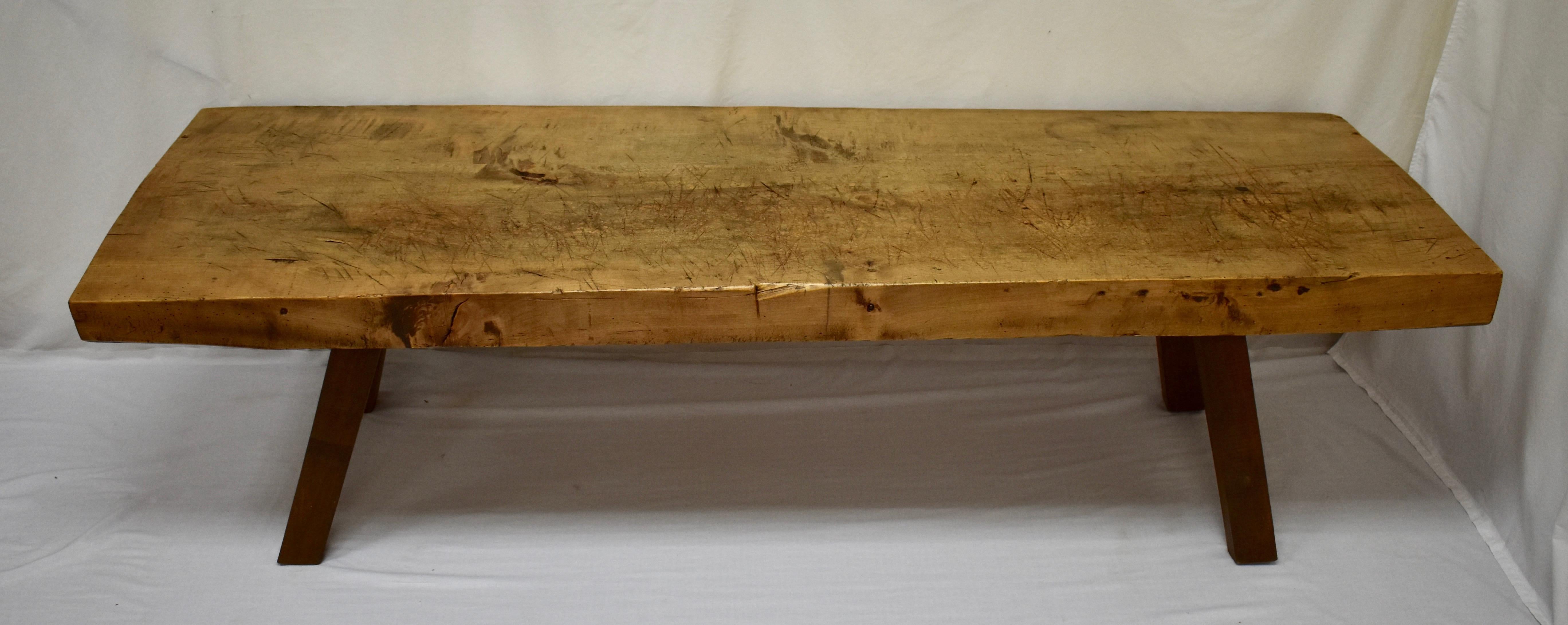 This is a truly massive oak pig bench low table, quite the largest we’ve found recently. It stands on four sturdy hand-hewn splayed legs which are mortised into the underside of the top. The top itself is a single oak slab over 3” thick, with a