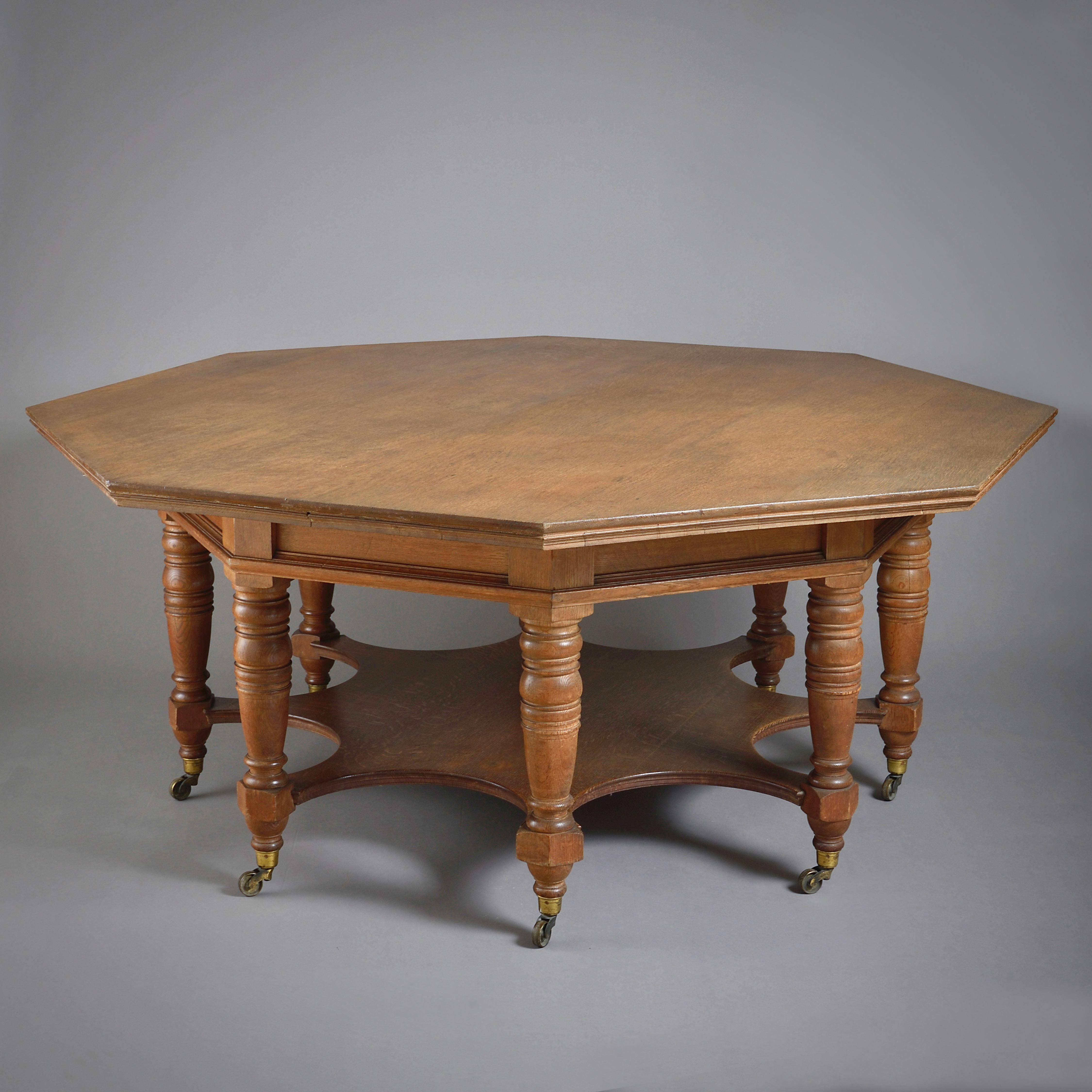 A massive octagonal oak centre table in the manner of Phillip Webb, circa 1875.

The socket castors stamped COPE & COLLINSON PATENT.