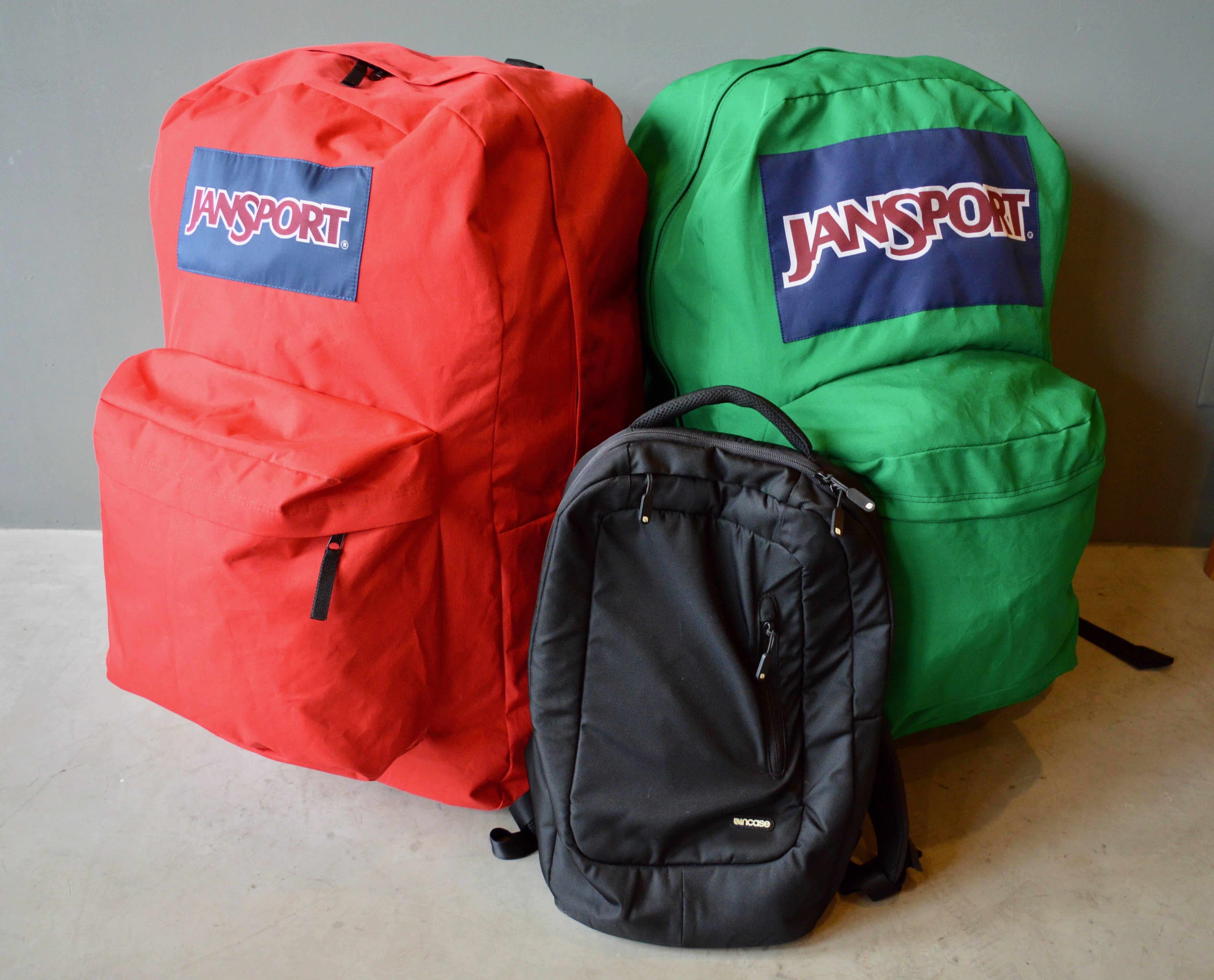 Massive oversized Jansport backpacks. One red. One green. Over 2.5 feet tall. 400% larger than a normal backpack. Cool advertising piece. Great object for a kids room. Priced individually.