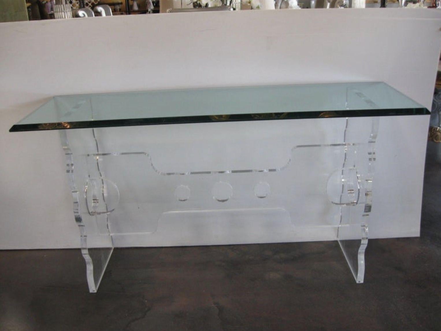 Massive pair of acrylic consoles with 1 inch glass top. The thickness of the lucite is 1 and 1/4 inches.