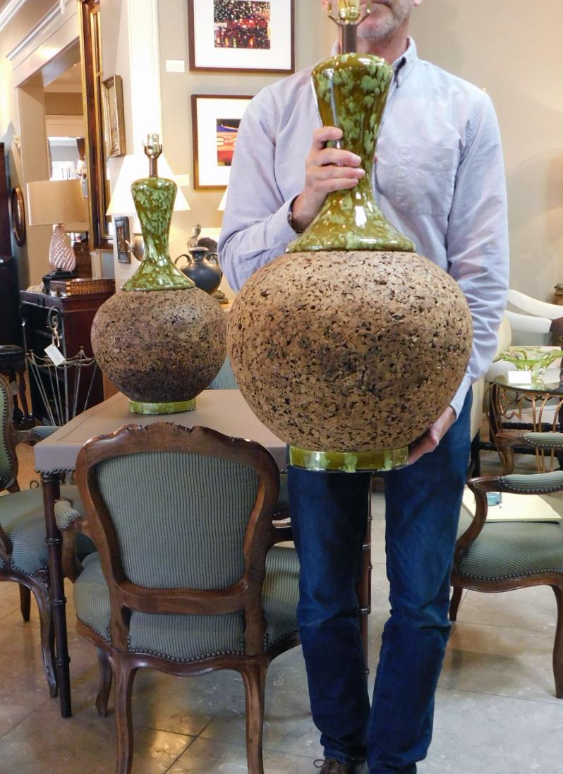 Great statement lamps with long flaring ceramic neck above a spheroid cork body resting on a similar ceramic base, measures: 25