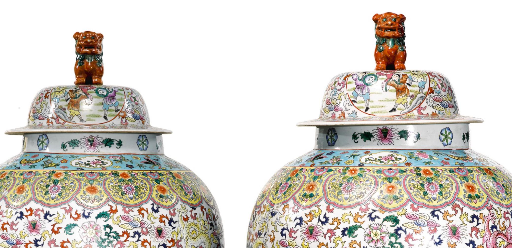 A massive pair of Chinese famille rose porcelain baluster vases or jars and covers
circa early 20th century 

Painted with battle scenes, dragons, and flowers with fu dog finials.
bases bearing apocryphal four-character Tongzhi