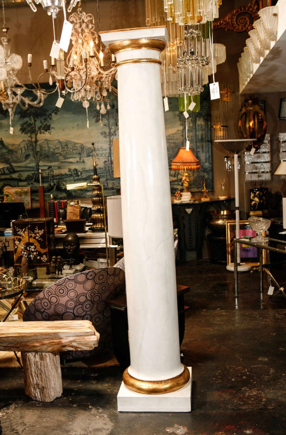 Massive pair of Italian columns completely restored in faux paint and gold leaf. The base is 18
