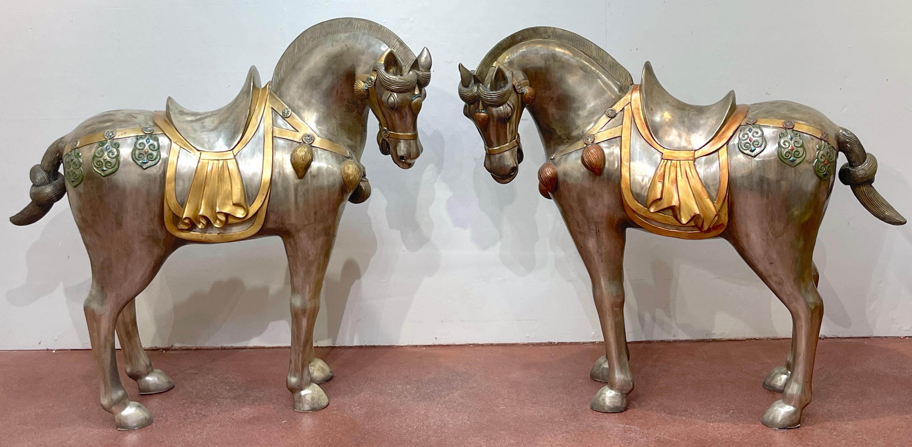 Massive Pair of Mid Century Silvered Bronze and Enameled Tang Style Horses, Style of Tony Duquette
Late 20th Century

Presenting an exceptional find: a pair of Mid Century Silvered Bronze and Enameled Tang Style Horses, featuring the distinctive